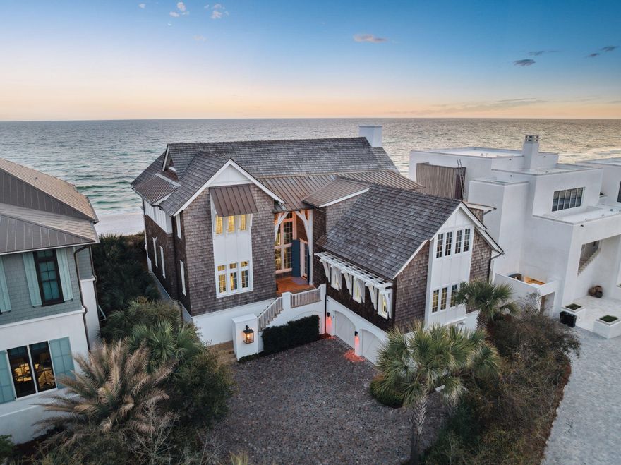 Located at 96 Camp Creek Point Drive in Inlet Beach, Florida, this exceptional beachfront residence offers a harmonious blend of modern elegance and timeless charm. Designed by renowned architect Geoff Chick and constructed in 2020, the home spans 6,259 square feet on a 0.17-acre lot, featuring six bedrooms and seven and a half bathrooms.The home's robust all-concrete construction is complemented by cedar shake siding, seamlessly integrating with its coastal surroundings. A decommissioned brick paver driveway, sourced from Charleston, South Carolina, leads to a two-car garage and a distinguished second-floor entryway. Inside, the open-concept living, dining, and kitchen areas are adorned with reharvested ceiling beams from Ohio and shell stone flooring, creating an atmosphere of sustainable elegance. The gourmet kitchen boasts solid Taj Mahal quartzite counters, premium Sub-Zero appliances, a Viking range, and a metal island with an integrated sink and bar seating. Custom Waterworks fixtures and modern flat-front cabinetry further enhance the space.

Each bedroom is thoughtfully designed with features such as automatic blinds, custom grasscloth wallpaper, and ensuite bathrooms equipped with paneled linen closets and hand-painted Mackenzie-Childs accents. The master suite serves as a private sanctuary, offering a vaulted ceiling, silk-stitched wallpaper, a marble bathtub, dual marble vanities, and a private gulf-front balcony.

The residence includes a standalone suite over the garage, reminiscent of a charming carriage house, complete with a full ensuite bath and bunk beds. Pet-friendly features are integrated throughout, including a dedicated dog room with a Dutch door, a hidden dog gate, and a dog-washing station with a quartz sink.
Designed for both relaxation and entertainment, the home features a spacious media and game room, perfect for gatherings. This thoughtfully curated space includes plush seating, a large-screen display, and built-in surround sound, offering a cinematic experience from the comfort of home. A ping pong table and custom cabinetry further enhance the room's functionality, making it an inviting retreat for both kids and adults alike.

Outdoor spaces are equally impressive, featuring a gulf-front pool with a shallow shelf suitable for pets, a spa with a waterfall feature, and a screened porch with an outdoor kitchen. A private Trex boardwalk provides direct access to the pristine beach.

Modern conveniences include a tankless hot water system, multiple laundry areas, a private elevator, whole-home automation via Crestron, whole-home audio, and over 2,000 square feet of climate-controlled storage.

This property epitomizes coastal luxury, offering an unparalleled living experience in the coveted Camp Creek Point neighborhood, just minutes from Scenic Highway 30A's array of shopping and dining options. Inquire today to schedule a showing. 
