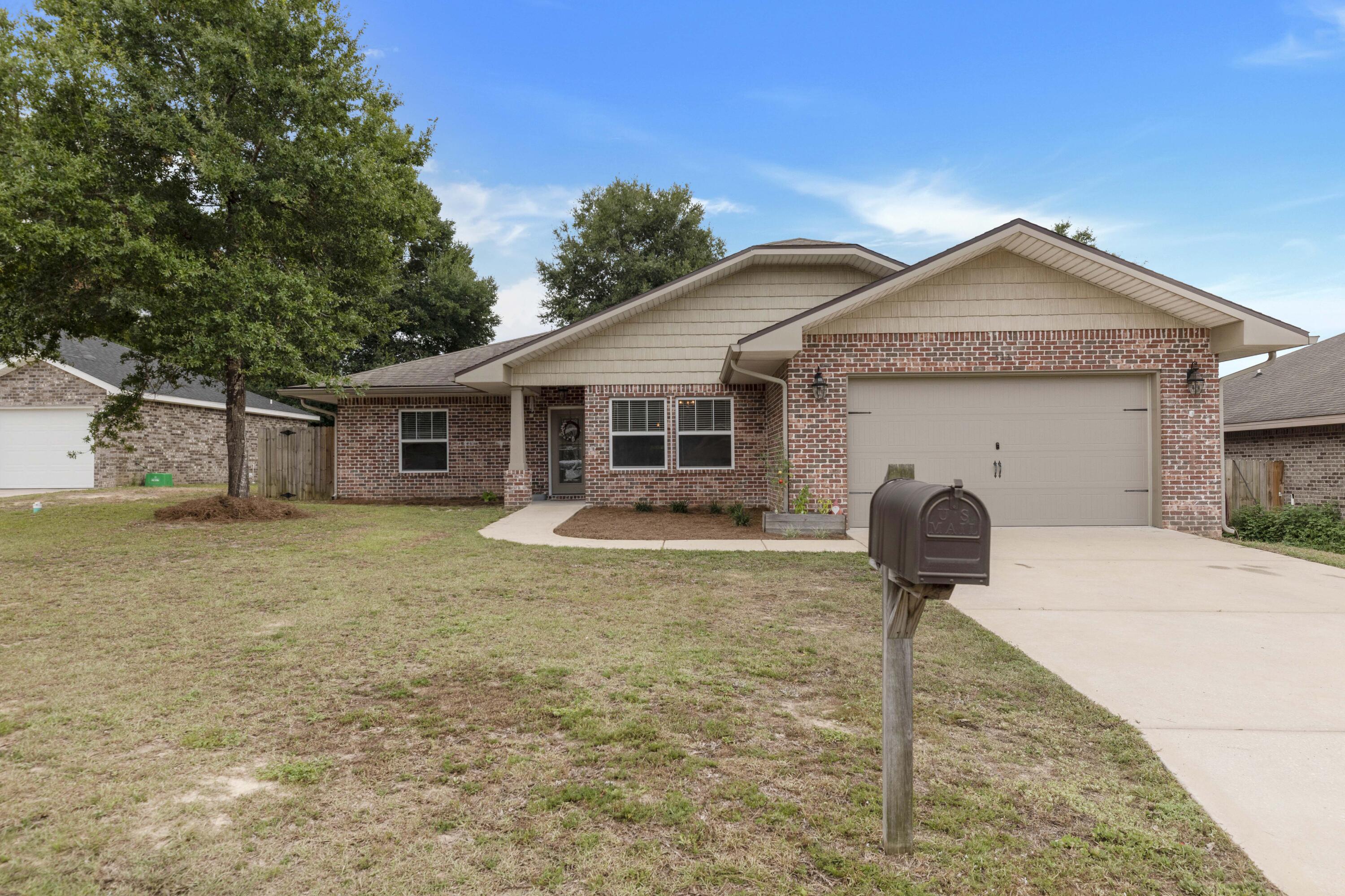 $5,000 towards Buyer's Closing Costs! Beautiful 4 bedroom 2 bathroom all brick home built in 2017! Custom floor plan by multiple award winning builder and 2017 Parade of Homes winner! This home offers 10 ft. ceilings w/ impressive crown molding, 12x24 offset tile flooring, and 5 1/4'' baseboard throughout the main living areas. On the exterior of the home, this Craftsman style home has a covered porch w/ columns and 8 ft leaded glass door. The privacy fenced backyard has shade trees and a generous covered open porch perfect for entertaining. The exterior also has an irrigation system, rain gutters and a two car front entry garage and driveway. As you enter the home you are greeted by a long foyer escorting you to the living room. The large living room boasts tile flooring, crown molding