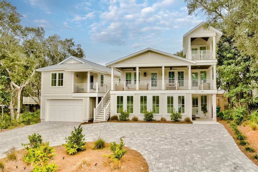 Ideally situated on an extra-large lot with a new, heated resort-style pool, this completely renovated home features a newly constructed oversized garage with carriage house and is only a short stroll to the white sand and emerald waters of the Gulf. Boasting seven bedrooms and seven bathrooms (sleeps 22), attention to detail is abundant throughout. Features include a large, open living space with a chef's kitchen, wood floors, custom trim work, exposed brick, shiplap, marble tile, designer finishes, and beautiful furnishings. The home flows seamlessly to the outdoors, combining exceptional indoor and outdoor living. Listen to the surf from the porch or heated, private pool, and enjoy the large private yard complete with mature oaks and lush landscaping with plenty of room for sunbathing,
