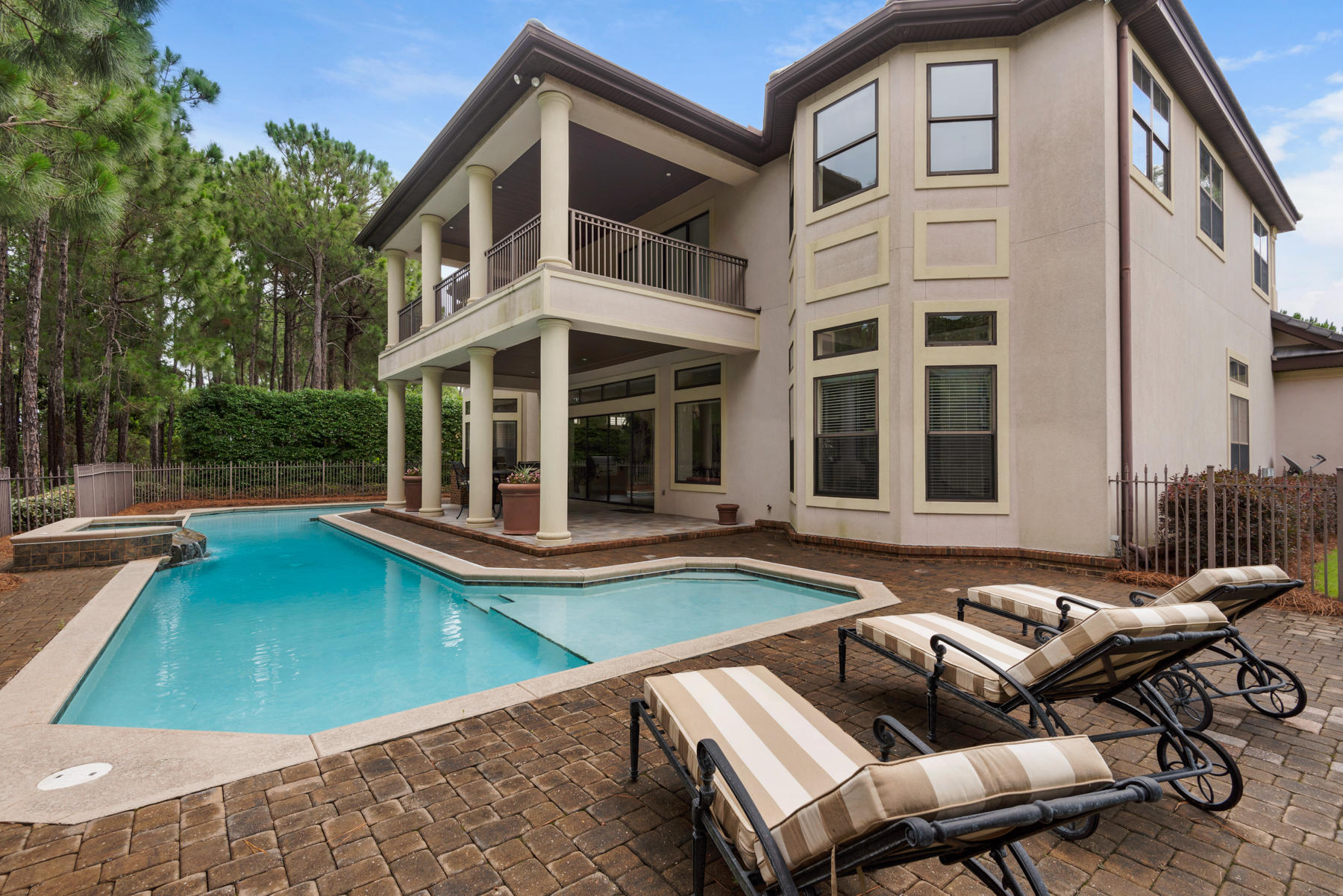 This beautiful custom built home is sure to please and spares no attention to detail. The first impression upon entering is a large foyer with two spiral stairways and a gorgeous chandelier. The downstairs features an open floor plan concept complete with separate bar area, large great room, and sliding glass pocket doors that open completely to the covered outdoor living space with barbeque area and large pool with swim up bar. This house is perfect for the buyer that enjoys entertaining. After a night of fun everyone can retreat to the fully equipped movie theatre. The in-home theatre is complete with state of the art surround sound, theater seating, and his and hers bathrooms.