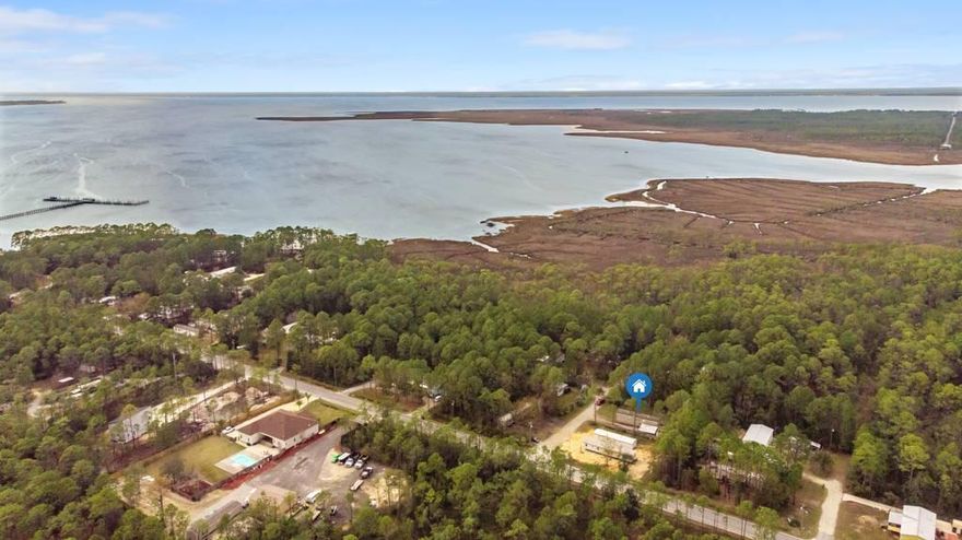 Well built and maintained two bedroom, two bath mobile home on double lot. 8 foot ceilings throughout and fresh paint. Carport and air conditioned  12x18 metal storage building ready for a separate office or workshop. Blocks from the bay, parks, nature trails and a short drive to the Gulf!  100 x 125 large lot perfect to play with the kids, build a second home, add another mobile home or tiny home to rent out, the possibilities are endless. No HOA fees. P