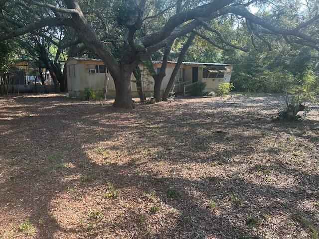 Uninhabitable in its present condition, the mobile home on 1/3 acre is conveniently located to EVERYTHING in Navarre! Many new homes surround the neighborhood where you, too, can carve out your little 'Piece of Paradise'. All utilities are available; if handy, you can put in some sweat equity, fix it up, and you can call it home. Minutes to the sugar white sand beaches of Navarre that locals still refer to as Florida's best-kept secret! In the Santa Rosa 'A' rated school district. Let's work together to get you onto your land today, so you can celebrate tomorrow.