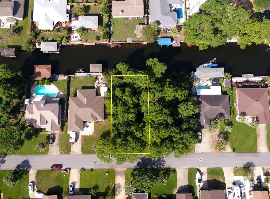 **Build Your Dream Waterfront Retreat!** Discover a rare opportunity to own a beautiful homesite in the highly sought-after waterfront community of Polynesian Islands in Gulf Breeze. With 70 feet of waterfront, you have the perfect canvas to design your ideal boat house or lift and enjoy effortless days on the water. This spacious lot offers ample room to create the custom home and pool you've always envisioned--bring your plans and your imagination. Privacy is a standout feature here: the adjacent lot to the right is owned by the neighboring home and is planned to remain natural, giving you added space and a serene setting with no immediate neighbor on that side. Living in Polynesian Islands means enjoying a community boat ramp, top-rated Gulf Breeze schools and unbeatable convenience to Pensacola Beach, Navarre Beach, Pensacola International Airport, and vibrant downtown Pensacola. Survey available in documents. Secure your slice of coastal paradise and start building the lifestyle you deserve.