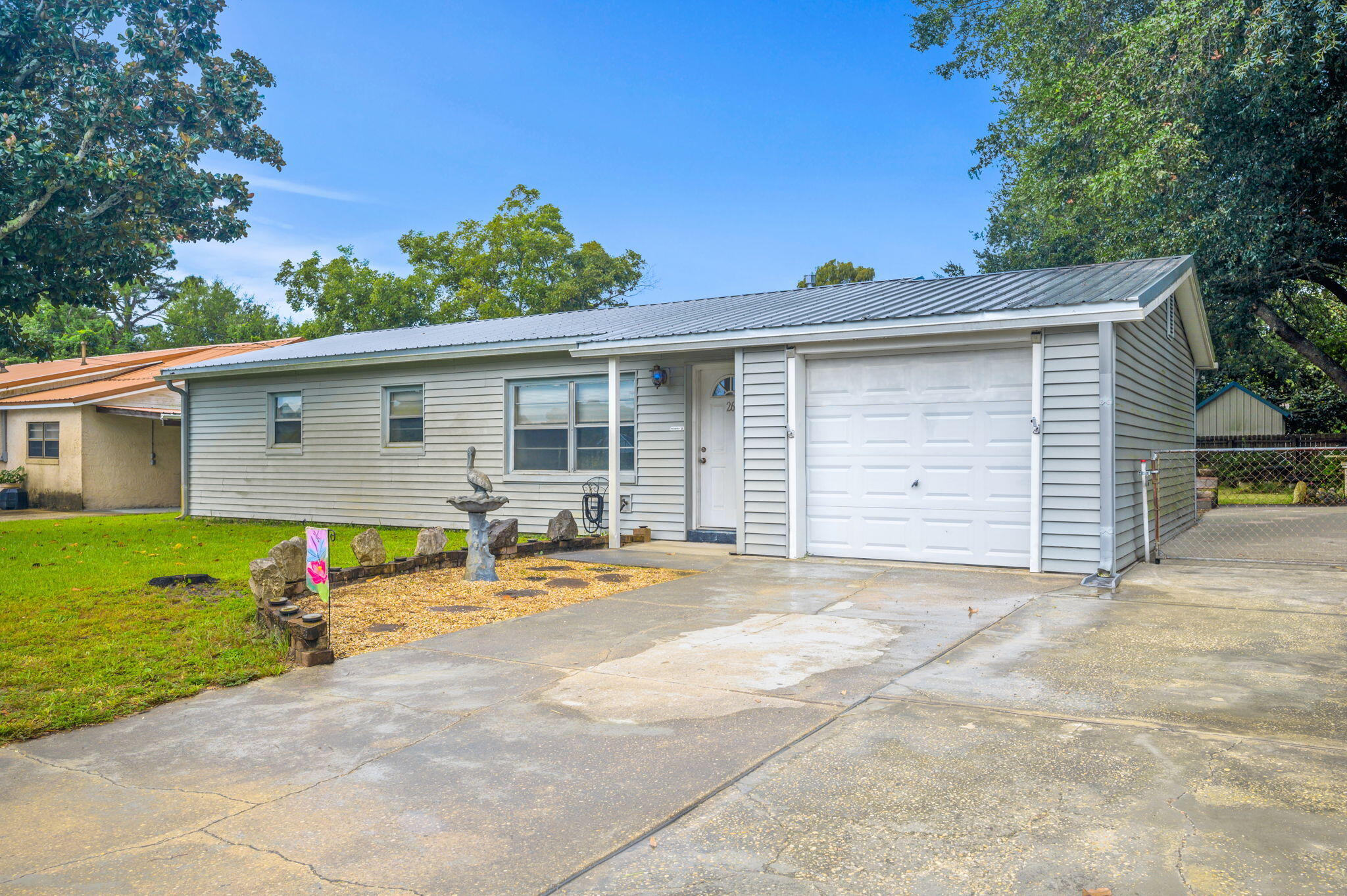 $10,000 ALLOWANCE Use it for floors, bathroom or put it towards closing costs! This fantastic home is in a great location just being minutes from the beaches, bases, shopping, restaurants, and schools! Plus you are right across the street from the recreation center on Jet Dr. which adds a nice attraction for the kiddos! This home features a laundry room off the kitchen, a newer metal roof, a large driveway with additional parking and large gate to access to the oversized backyard, perfect for parking or storing your boat or RV. The sprinkler system is on a well system to help save on your water bill while the rest of the home is on city water. A new wash machine and range were just purchased. All of them plus the dryer will convey with the home. Call for your appointment