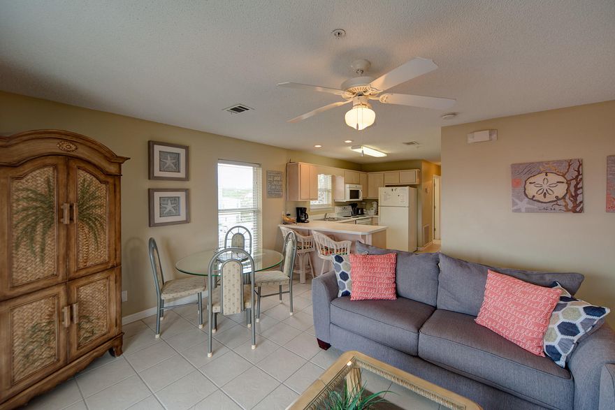 Stunning Villa One Block to Beach, Convenient to EverythingSeagrove is the perfect place to pedal between restaurants and shops, then bicycle on home to Rollin' Tides Villas and park your transportation in one of the covered bike spaces. Your 3-BR, 2-BA condo sports soft amber tone walls, alabaster white trim and 6-panel interior doors. Ceiling fans throughout enhance air circulation and light up every bedroom and the living room. A stacked washer-dryer heightens convenient one-floor living.Modeled on the great room concept, the fresh white kitchen is open over a breakfast or wine counter to the dining and living space. Dual stainless steel sinks have a window over them for natural daylight and checking on the weather. Expansive glass doors open to the balcony, which is also accessibl