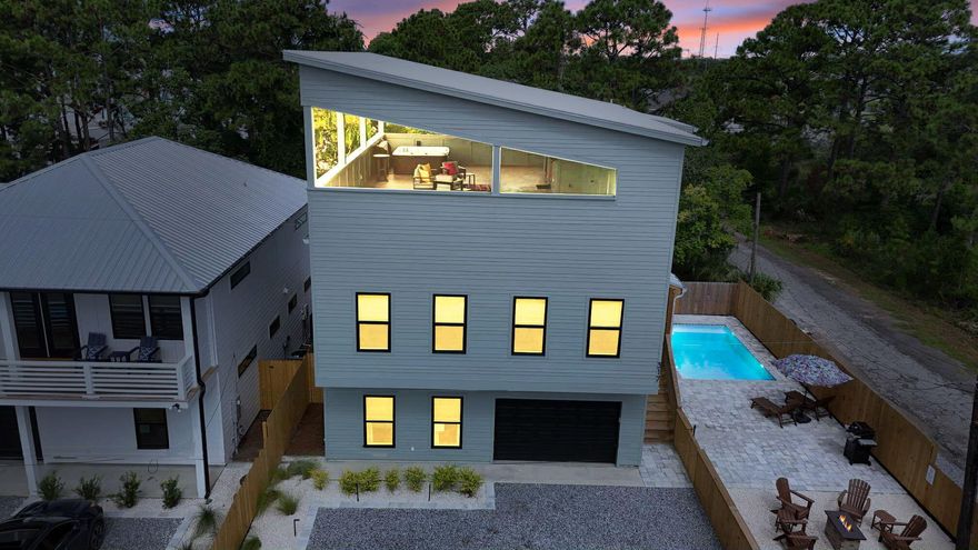 Investor's Dream: New Construction with $130K+ Projections - Live, play, and invest just 0.3 miles from the beach in this brand-new, fully furnished 4-bedroom, 3-bath plus 2 half-bath, three-story coastal retreat. Designed for both luxury and income potential, the home boasts a stunning third-floor entertainment terrace with a hot tub, billiard table, wet bar, Smart TV, and half bath, while outside you'll find a saltwater heated pool, fire pit, and outdoor TV for the ultimate vacation experience. This turnkey property is already renting on Airbnb with projections around $130,000 per year and features three king bedrooms plus a bunk room, with two of the bedrooms offering en suite baths. Every detail has been elevated with Smart TVs throughout, Samsung appliances, and an epoxy-finished garage with EV charger and second laundry hookup. Built with durable construction that includes 2x6 framing, spray foam insulation, Hardie board siding, a metal roof, and dual-zone HVAC allows you to invest in confidence. Perfectly located near Pier Park, Top Golf, Dolly Parton's Pirate Voyage, and the dining and shopping of 30A, this music-themed Airbnb offers the rare combination of lifestyle and strong rental incomemaking it a true investor's dream.