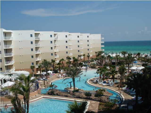 The best of Fort Walton Beach's resort condominium offerings - WATERSCAPE- located on a whopping 490' of the most spectacular beachfront! #B528-H is a furnished C.2 plan, 1br/2ba unit in Building B (inside courtyard, west building)with balcony facing the interior pool amenities and the sugar white sand beaches and emerald green waters of the Gulf of Mexico. Gross income $26,110/2013; $31,175/2014 - a real performer! This is a handicapped equipped unit with lower kitchen counters, microwave on the counter and bars in the bathroom. This is the only property with this level of amenities large beach front, dune crossovers with 4 freshwater showers, 2 foot washing stations leading up to a spectacular split level courtyard with 2 pools and multiple decks- one offering a
