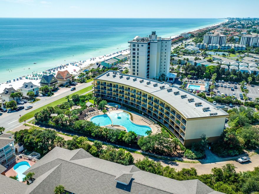 This is a rare chance to secure a beautiful fifth-floor condo at the coveted Beach Resort. This updated unit comes with the best gulf views in the building along with deeded beach access and deeded covered parking, making it highly attractive. The bright open floorplan draws you in, passing the mahogany kitchen and comfy sitting area as you head to the full-width balcony. Full-height sliding doors frame mesmerizing pool and gulf views. It's an enviable spot to relax with drinks at sunset or dine alfresco in the gentle breeze. Noteworthy features in this well-maintained condo include tile flooring throughout, 9-1/2-foot ceilings, crown molding, plantation shutters and an energy-saving Nest thermostat. The updated kitchen is particularly attractive with classic cabinets and new appliances beneath gorgeous granite countertops. The new sink has a useful garbage disposal and there's a pretty glass tile backsplash. Pendant lighting illuminates the breakfast bar where you can perch with friends enjoying drinks and snacks before heading out for dinner. Head down the hallway to find a washer-dryer closet and custom bunks to complement the master bedroom. The primary ensuite bath has a granite vanity and shower over tub. The second bathroom has custom shelves and a walk-in shower making the unit live like a 2/2. Never previously rented, this condo enjoys a full range of amenities including two pools (one seasonally heated), a fountain, decks, grills and a hot tub. This intimate resort of just 64 units has 300 feet of beach access making it easy to enjoy morning strolls with pelicans and dolphins, swimming, shelling and having fun. All this is within easy reach of Henderson Beach State Park, Destin shopping, dining, golf and amenities.