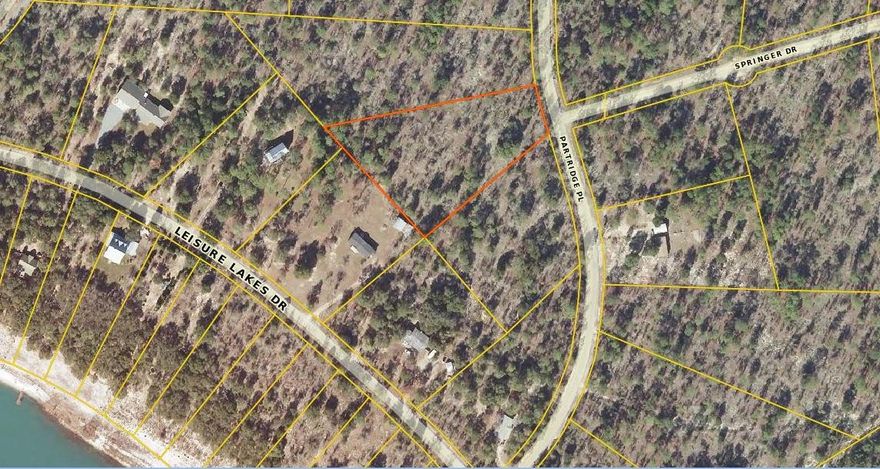 Your new getaway contains 2.58 acres of beautiful wooded land that's in a great location in Leisure Lakes subdivision. Build your home in this gorgeous gated community! The subdivision offers you a guard building with security guard at the entrance, two lakes, floating dock, white sandy beaches, a swimming pool, basketball and tennis courts, a playground, equestrian trails, boat launch, and fishing. Just minutes to the beaches of Panama City Beach and the International Airport. View plat map for location of lot.