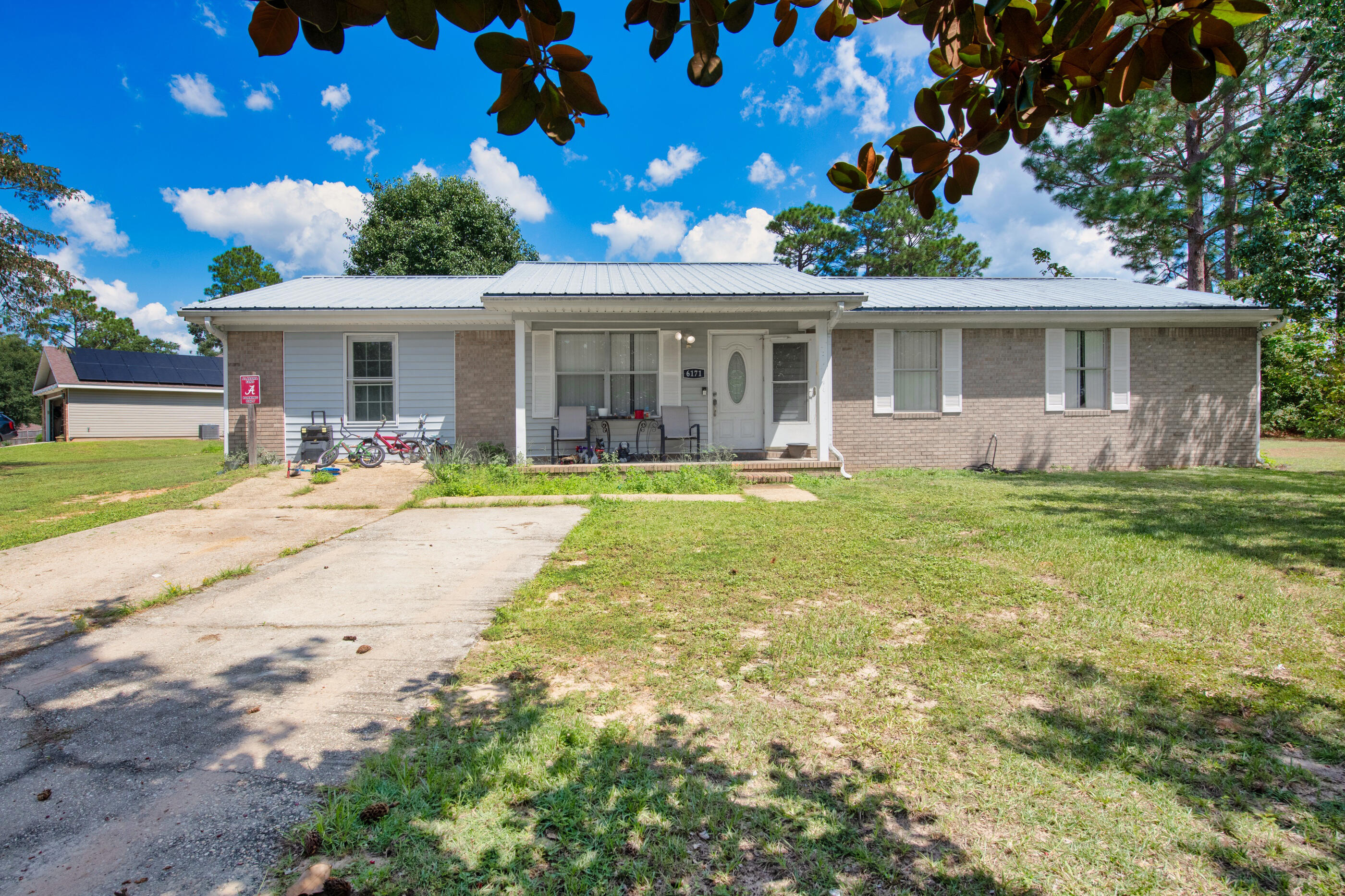 Welcome to the peaceful surroundings of north Crestview. This all-brick ranch-style home offers both comfort and convenience. Located on a spacious .39-acre corner lot, the property boasts an oversized fenced yard, perfect for family gatherings, gardening, or relaxing outdoors. The inviting layout includes 4 bedrooms +bonus room, 2 full baths, and an open living space connecting the living, dining, and kitchen areas, making it ideal for both everyday living and entertaining.Step outside to enjoy the best of Florida's outdoor living with a large covered back porch, perfect for morning coffee or evening barbecues, and a welcoming covered front porch that gives the home its cozy, inviting appeal.In addition to its charming exterior, the home is built for durability and efficiency. The metal roof adds to the home's resilience, while the energy-efficient electric HVAC system, updated in 2020, ensures year-round comfort. You'll also appreciate the reliable Auburn Water System and the availability of Cox Cable for all your connectivity needs. Lower county property taxes and reduced electric bills make this home as practical as it is charming.