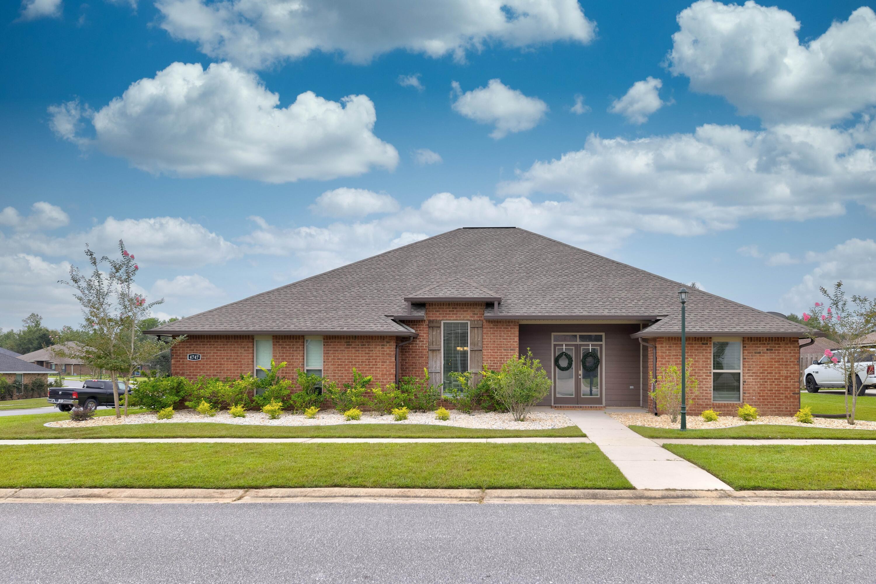 Enter through the stately double doors to a sprawling, meticulous brick home. The open tiled foyer flows into the spacious family room with the formal dining room to the left. A stylish kitchen with lots of granite counter tops a farm sink, stainless steel appliances, including the refrigerator and island with granite top spice rack and cabinets. Hop up breakfast bar provides extra seating area and plenty of room for a large kitchen table in the breakfast nook overlooking the beautiful backyard. Split floor plan with master bedroom tucked in the back corner for privacy, double granite vanity, tiled shower, garden tub and 2 walk in closets complete the bathroom. Two additional bedrooms share a full bathroom on the other side of the home while a fourth bedroom is in the back corner