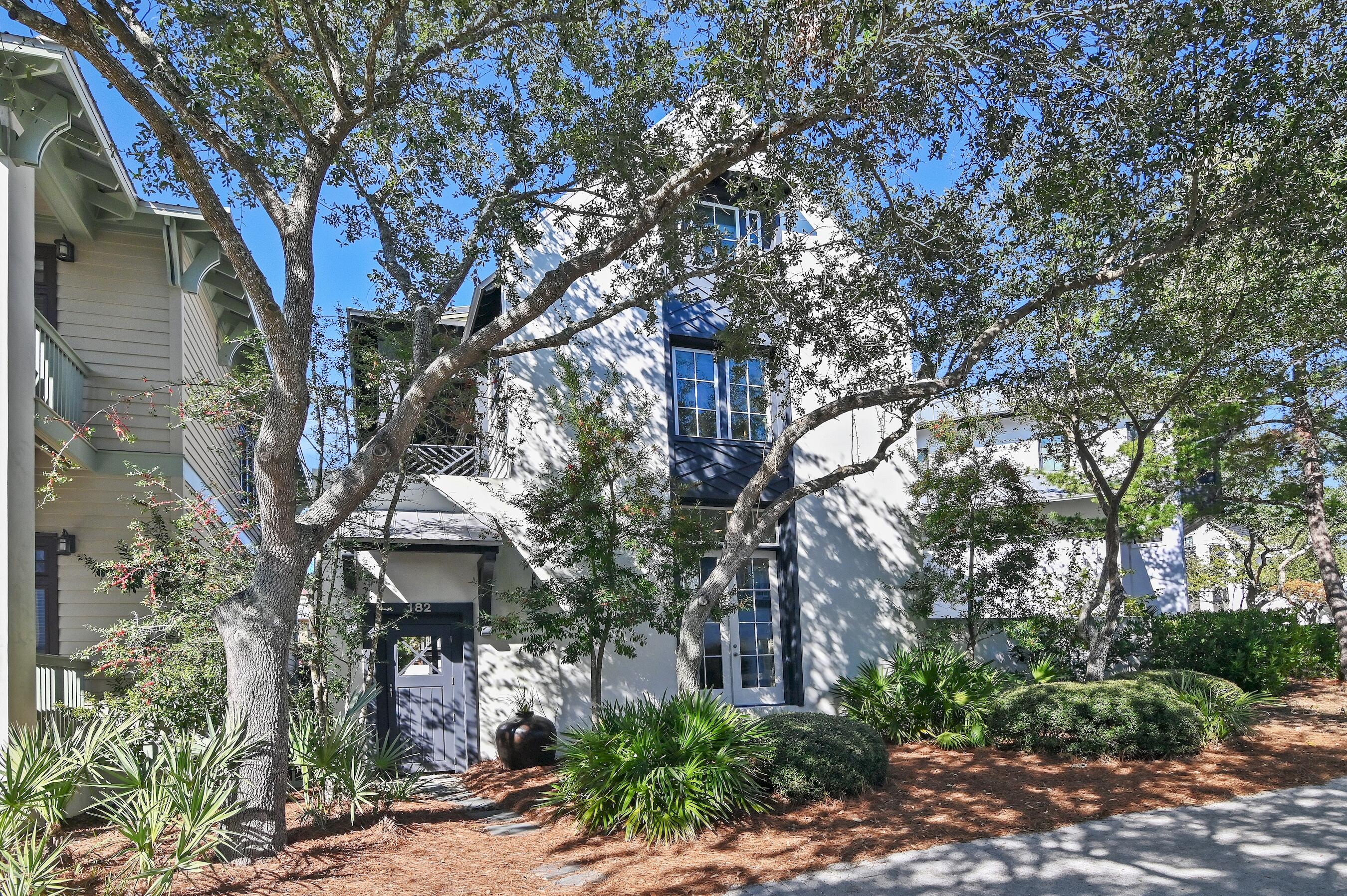 This home was designed to capture the essence of coastal living. The open floor plan flows effortlessly from the living area to the covered porch and courtyard, where a private pool enhances the indoor-outdoor connection. The courtyard creates a serene, private retreat, perfect for relaxation, entertaining, or dining al fresco.Ideally situated in the quieter, less-traveled area of Rosemary Beach, this home offers an ideal balance of privacy and convenience. Just two blocks from the Fitness Center, Sky Pool (indoor), Owners Club, and Racquet Club, you can easily walk the boardwalk to beach access. Enjoy world-class amenities right at your doorstep.The architectural design of this home draws inspiration from the timeless styles of the West Indies and New Orleans, blending elegance with Southern charm. The exterior showcases a combination of wood siding and stucco masonry, offering a perfect balance of warmth and sophistication. Cantilevered porches and French doors accentuate the balconies, enhancing the home's coastal allure.
Inside, the home features 12-foot ceilings that create a spacious and airy atmosphere. Coastal hardwood flooring throughout, perfectly complementing the natural light from the large-scale windows. A striking wrought iron railing stairwell gracefully leads to the upper levels. The living room is centered around a cozy fireplace, offering a warm and inviting space for relaxation. The property also offers the potential to add a carriage house with a two-car garage. This home is offered fully furnished, with an established rental history and pre-bookings secured for 2025.
