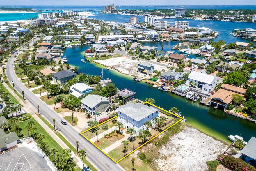 JUST REDUCED! A fabulous waterfront property with so much to offer! This classic beach home enjoys a prime location on Gulf Shore Drive, for easy access by car, as well as on a canal just off Destin Harbor, for easy access by boat! With 3 stories, plus decks on each, it enjoys great views of the Harbor, Gulf of Mexico, sunsets, and fireworks. Soaring ceilings, artistic chandeliers, and beautiful, real heart pine floors set apart the great room--an amazing place for family and friends to gather! The kitchen features marble countertops, leaded glass cabinets, dual breakfast bars, a sitting area (or breakfast nook), and large pantry closet. Since this home is all about enjoying the water, the large back patio, heated pool and long tie-up dock are another focal point. The dock includes water, electricity, and a jet ski port.
               
The home enjoys 4 master suites with ensuite baths, most with dual sinks. The lower level is effectively its own apartment, with a large living space, dining area, and its own kitchen. One of the original 2 garages has been converted to a bunkroom for six. Subject property is being sold furnished, some exclusions apply. 

With the sparkling white sand beach just across the street and great restaurants, entertainment and shopping venues of the Emerald Coast just a short drive or boat ride away, this classic family home with unique touches will bring great enjoyment for years to come!