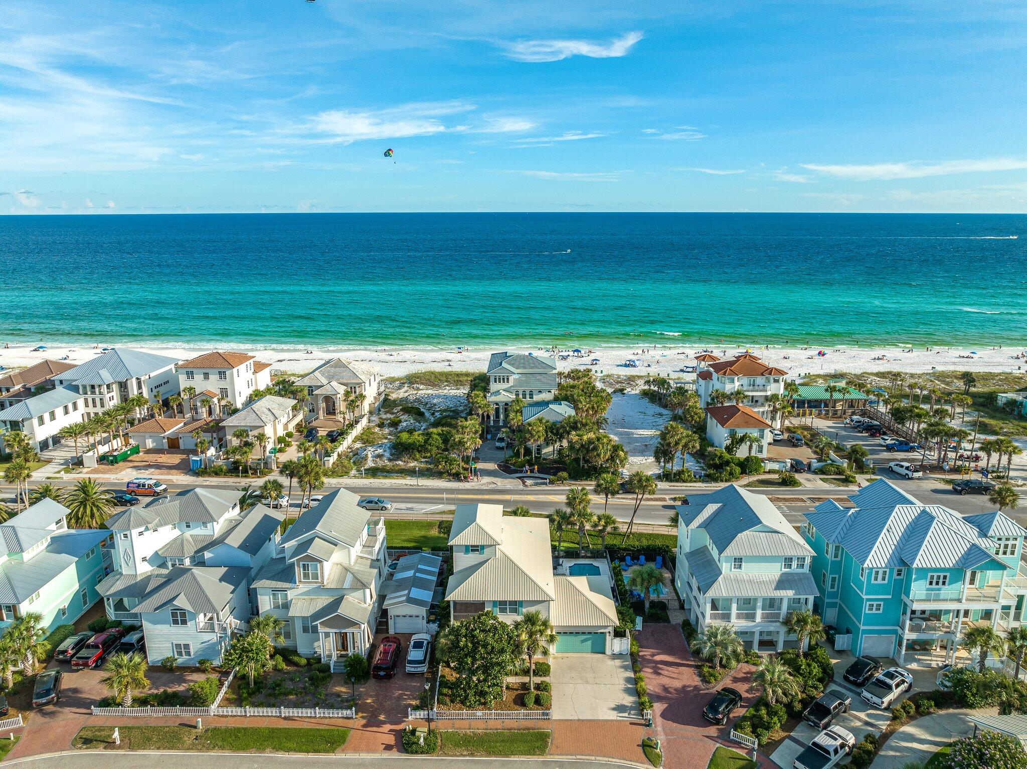 Aggressive price reduction! Nestled in the popular Crystal Beach neighborhood of Crystal Shores. This home is conveniently located right across the street from the Gulf of Mexico! The home has a spacious three-story floor plan with 5 bedrooms and 5 full baths and forever gulf views. Upon entering this newly renovated home, you are greeted by the living room, kitchen, and dining room all thoughtfully placed through an open floor plan. The living room provides comfortable seating for all. The fireplace below the wall-mounted TV provides warmth and a delightful atmospheric touch. In the kitchen, you'll find a large breakfast bar, beautiful cabinetry, and quartz countertops. The kitchen also features a built-in wine rack. Additionally, the first floor is has a king guest bedroom.