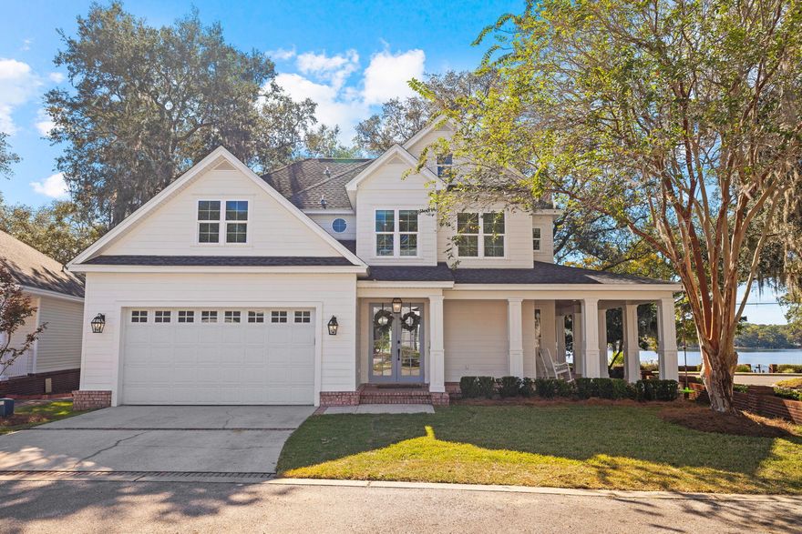 A picturesque waterfront setting on a prime corner homesite in the Grand Oaks community, this meticulously maintained residence is the perfect blend of comfort, style, and tranquil living. The home is situated off the water and offers panoramic views of Boggy Bayou, creating a serene backdrop to your daily life. The property also conveys 25 feet of bayou frontage; complete with a deep-water dock and a private boat slip, making days spent on the water a breeze. The large wrap-around porch with v-groove pine ceilings adds Southern charm and serves as an inviting space to relax and experience incredible sunsets over the Bayou.