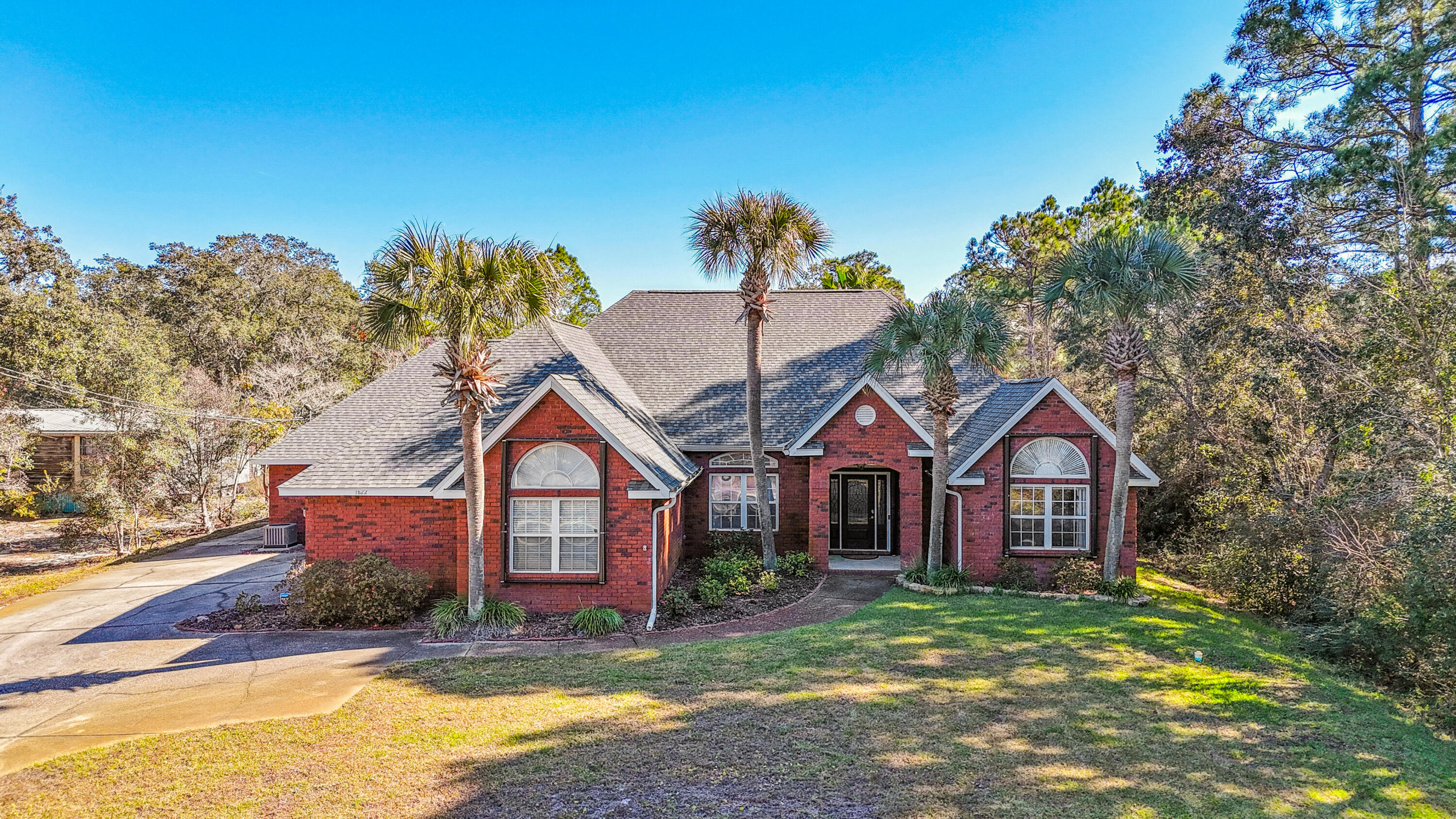 Located on a serene street leading to the Santa Rosa Sound, this home has something for everyone! Do you need 5 bedrooms? How about a 9-foot-deep saltwater pool with a spacious, private backyard? Need storage? Those, along with boat or RV parking (50 amp RV hookup), large oversized attached 3 car garage, detached 2 car garage/workshop, hurricane shutters, and a whole-house generator are just some of the extra features this beautiful home sports.  Inside, the home has been meticulously cared for and has upgrades too numerous to count! The kitchen includes a large walk-in pantry, butcher block island, and stainless-steel appliances.  One of the two living areas on either side of the kitchen has a cozy gas fireplace and the other a more private area to relax. More... Also nearby, is a formal dining room enclosed by French Doors. Enjoy lounging in your spacious primary suite complete with hardwood floors and a trey ceiling. Attached to that is the primary bath featuring a new on-demand water heater which feeds the three showerheads in the oversized shower, a large walk-in closet that has an abundance of room and even an additional closet for linens. Houseguests can enjoy privacy on the other side of the split-floorplan in a large suite, with an attached bath and walk-in closet.  Two additional bedrooms are connected by a dual bathroom.  Also located on this side are the laundry room, half-bath and entrance to the attached oversized three-car garage.  If you're not convinced yet, you need to check out the fully enclosed Florida room (heated and cooled) or the screened-in porch just off the kitchen.  One more bedroom (currently being used as an office) is located in the front of the house.  Just down the road is the deeded access entrance to the Sound-no HOA or Flood Insurance required for this extra. Upgrades are too numerous to list, but include: New Roof 2023; Septic Drain Field replaced 2023; Whole House Generator 2023; Natural Gas Fireplace 2024; Aerus Air Scrubber on HVACs 2024; Backyard privacy fence 2024, Bathroom updates (granite countertops, new sinks & faucets) 2024, Transferable Maintenance Contracts; Hurricane Shutters 2023; and a TV Antenna inside the attic. 