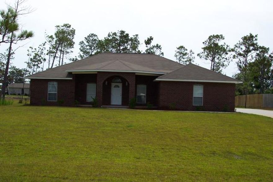 Custom all brick home in desirable Holley by the Sea. This home sits high on a 100x200 lot with custom features such as bull nose corners throughout, ceramic tiled floors in all wet areas, granite counter tops in kitchen and bathrooms, knock down textured ceilings, and coined brick corners outside. And very Large front & Rear Cover Porch !! This home is split Plan and there is a bonus room that can be used as an office or 4th bedroom. This home is on public sewer so there is plenty of room for a pool out back. Located close to the east entrance of Holey by the Sea, this home is near all the conveniences of Navarre, including the famous and beautiful white sandy beaches.
