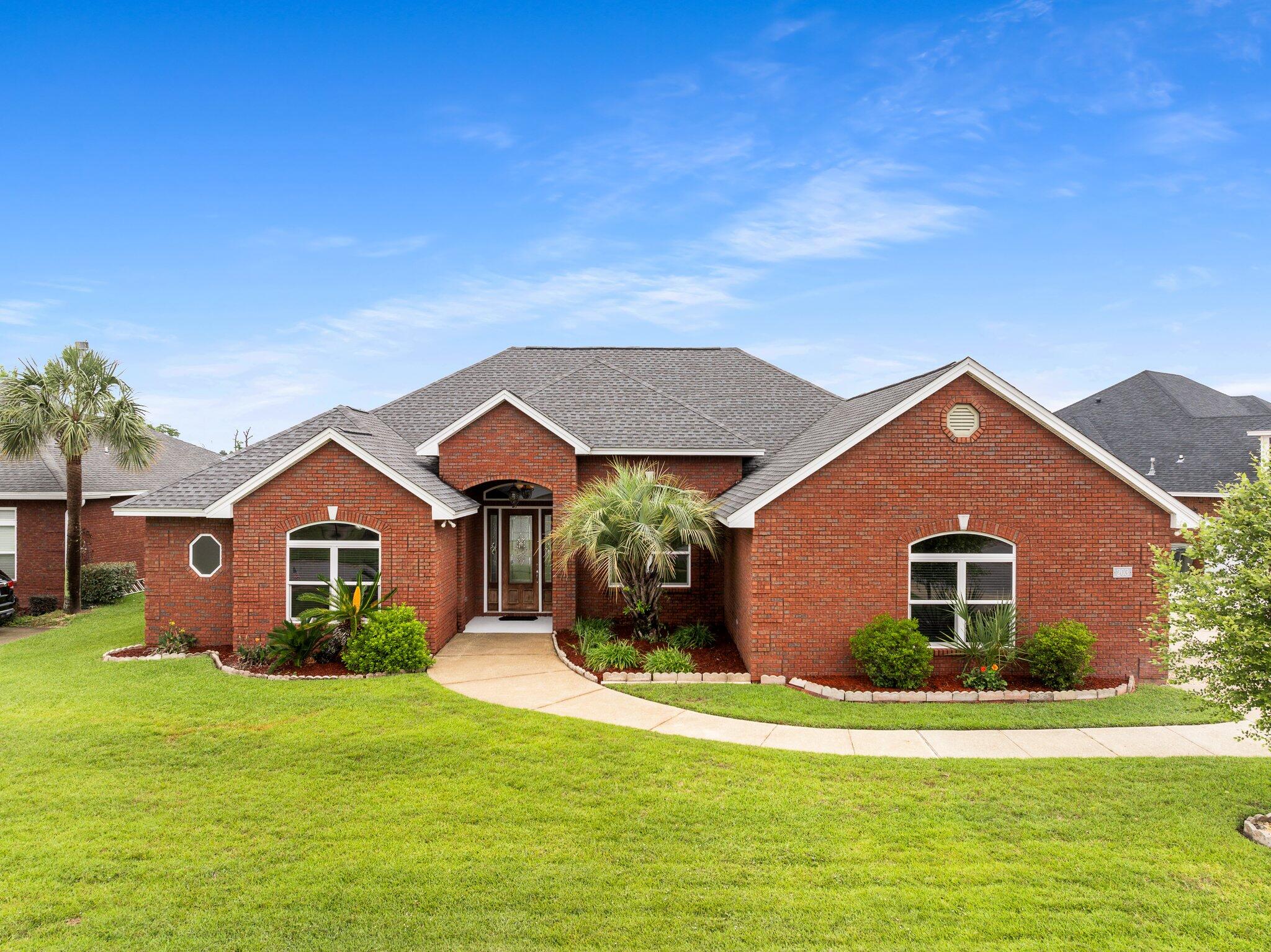 Welcome to 203 Landings Drive, a spacious 5-bedroom, 3-bathroom home with over 3,000 sq ft of functional living space and stunning waterfront golf course views. Located near the 15th hole of Nature Walk Golf Course, this home offers privacy and serene views instead of neighboring houses.Enjoy soaring 11' ceilings and picturesque water views from the moment you enter. The open-concept layout includes two living areas, a formal dining room, and a large kitchen with granite countertops, center island, and abundant prep space which is ideal for entertaining. The main living area features a gas fireplace and access to the outdoor patio.Off the main living area, there is a private bedroom with its own ensuite bath and separate entrance which could be utilized as a second primary suite, guest room, or mother-in-law quarters. Enjoy stunning waterfront views of the Nature Walk Golf Course from this room, framed by lush fairways, towering oak trees, and natural Florida pines. Nearby, two additional bedrooms share access to a full hall bathroom, offering comfort and convenience for family or guests.
The split-floor plan offers privacy, with the primary suite and an adjacent bedroom (ideal for office or nursery) separated from the additional three bedrooms. The spacious primary suite includes double closets, waterfront views, and an ensuite bath with soaking tub, updated walk-in tiled shower with bench, and double vanity.
This home offers upgrades from the durable hurricane rated, bomb and bullet proof windows to the updated luxury vinyl plank flooring. The residence boasts a pre-wired, four-zone surround sound system encompassing the formal living room, main living area, dining room, and outdoor entertainment space, delivering an immersive audio experience throughout. Additional features include existing natural gas lines and a newer instant gas hot water heater. A new roof was installed in 2019. For added peace of mind, the home is equipped with a generator connection that powers the primary suite, refrigerator, and hot water heater in the event of a power outage.
Positioned on one of the most expansive lots within the community, spanning an impressive 0.27 acres, this distinguished residence is ideally situated in Flood Zone X, eliminating the need for flood insurance. The property features an oversized driveway complemented by a discreet side-entry garage, providing generous and additional parking accommodations. Perfectly located just 15 minutes from premier shopping, fine dining, and vibrant entertainment venues, this exceptional opportunity is not to be missed. Arrange your private viewing today and experience the refined lifestyle this home affords.
