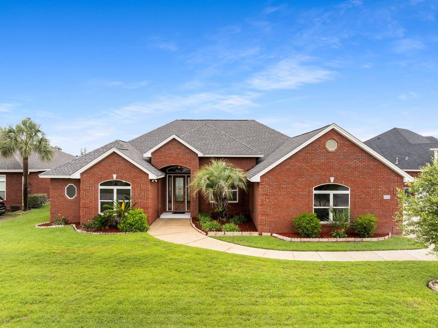 Welcome to 203 Landings Drive, a spacious 5-bedroom, 3-bathroom home with over 3,000 sq ft of functional living space and stunning waterfront golf course views. Located near the 15th hole of Nature Walk Golf Course, this home offers privacy and serene views instead of neighboring houses.Enjoy soaring 11' ceilings and picturesque water views from the moment you enter. The open-concept layout includes two living areas, a formal dining room, and a large kitchen with granite countertops, center island, and abundant prep space which is ideal for entertaining. The main living area features a gas fireplace and access to the outdoor patio.Off the main living area, there is a private bedroom with its own ensuite bath and separate entrance which could be utilized as a second primary suite, guest room, or mother-in-law quarters. Enjoy stunning waterfront views of the Nature Walk Golf Course from this room, framed by lush fairways, towering oak trees, and natural Florida pines. Nearby, two additional bedrooms share access to a full hall bathroom, offering comfort and convenience for family or guests.

The split-floor plan offers privacy, with the primary suite and an adjacent bedroom (ideal for office or nursery) separated from the additional three bedrooms. The spacious primary suite includes double closets, waterfront views, and an ensuite bath with soaking tub, updated walk-in tiled shower with bench, and double vanity.

This home offers upgrades from the durable hurricane rated, bomb and bullet proof windows to the updated luxury vinyl plank flooring. The residence boasts a pre-wired, four-zone surround sound system encompassing the formal living room, main living area, dining room, and outdoor entertainment space, delivering an immersive audio experience throughout.  Additional features include existing natural gas lines and a newer instant gas hot water heater. A new roof was installed in 2019. For added peace of mind, the home is equipped with a generator connection that powers the primary suite, refrigerator, and hot water heater in the event of a power outage.

Positioned on one of the most expansive lots within the community, spanning an impressive 0.27 acres, this distinguished residence is ideally situated in Flood Zone X, eliminating the need for flood insurance. The property features an oversized driveway complemented by a discreet side-entry garage, providing generous and additional parking accommodations. Perfectly located just 15 minutes from premier shopping, fine dining, and vibrant entertainment venues, this exceptional opportunity is not to be missed. Arrange your private viewing today and experience the refined lifestyle this home affords.
