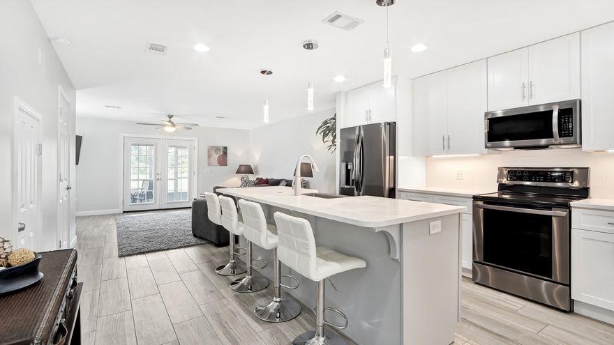 Remodeled to perfection and ready for YOU! 35K gross rental income in 2019, LOW HOA DUES and walking distance to the BEACH. Offering 2 bedrooms, 2 1/2 baths, and an amazing redesigned kitchen giving you that open feeling throughout the first floor. Almost 45k in recent updates that include Soft Close Kitchen Cabinets, Quartz Countertops, Farmhouse Sink, all new lighting throughout, Stainless Steel Appliances, Tile Backsplash, added Recessed Lighting, all New Ceiling Fans, and new Tile Floors throughout. Each bedroom offers an updated En Suite. The mater bath has a new vanity with granite, new toilet, and tiled walk- in shower with glass enclosure . The spare bathroom has new granite topped vanity with a tiled tub surround. A/C and water heater was replaced in 2018. New Grill conveys.