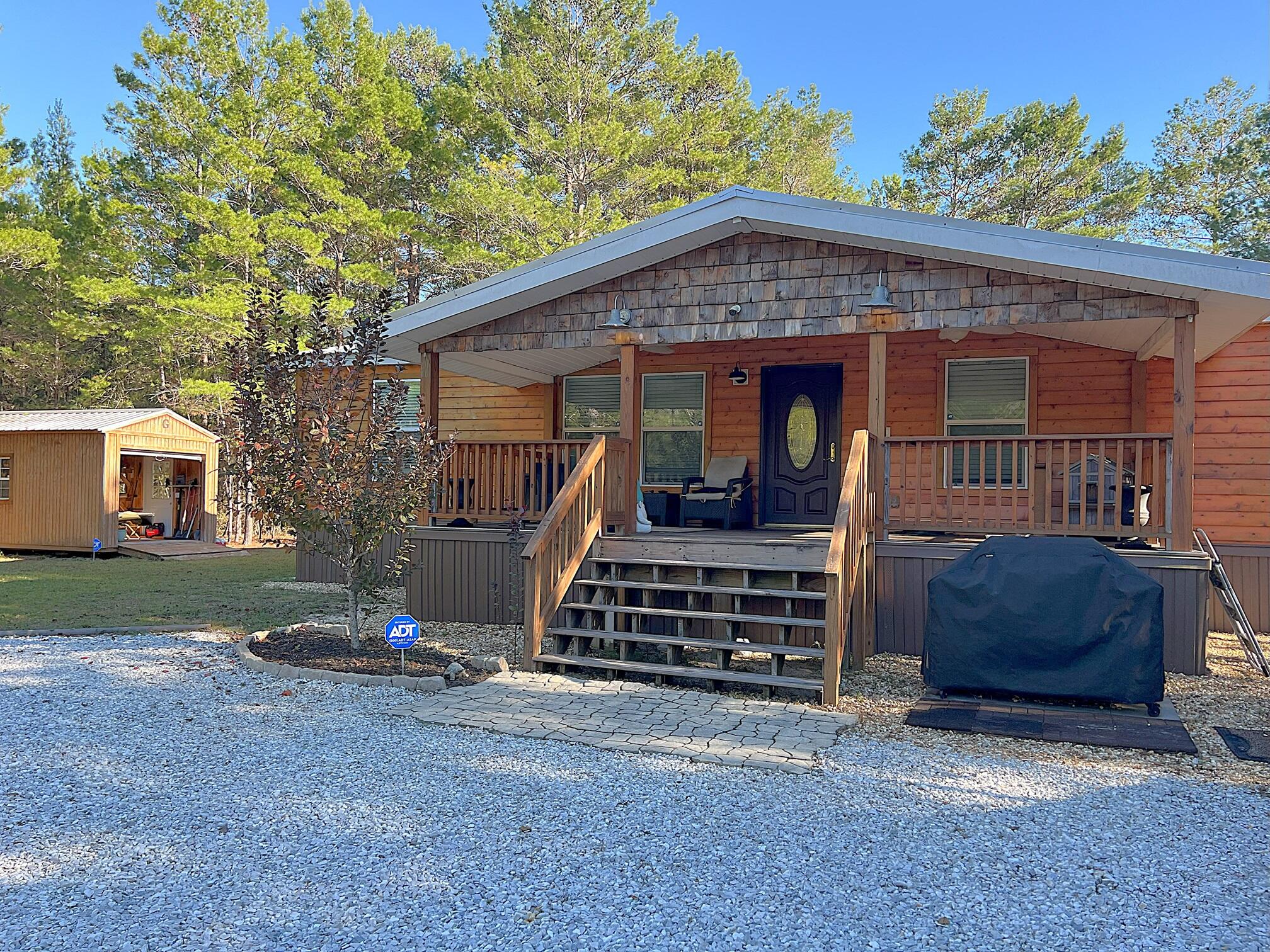 Must see custom renovated 2003 Champion mfd. home on apx. 1 acre (.97 per survey). All renovations completed between 2016 & 2019 (new metal roof & deck boards Aug. '19; New HVAC & ducts '18). Interior renovations include walls; flooring; both baths & kitchen completely renovated. Kitchen island, stainless steel appliances, plus wine fridge. Beautiful electric fireplace in living room. Exterior features cedar siding; 10x24 covered porch; 10x20 storage bldg/shop w/ power; Storage bldg. in front of home w/ 30 amp RV hookup; new 300' well. Home is set back nicely from the road. Conveniently located w/in 10 min. from Defuniak Springs & from I-10 in Mossy Head for a quick commute to Crestview, Niceville, Eglin AFB & FWB Airport. High speed streaming internet available. Schedule a showing today!