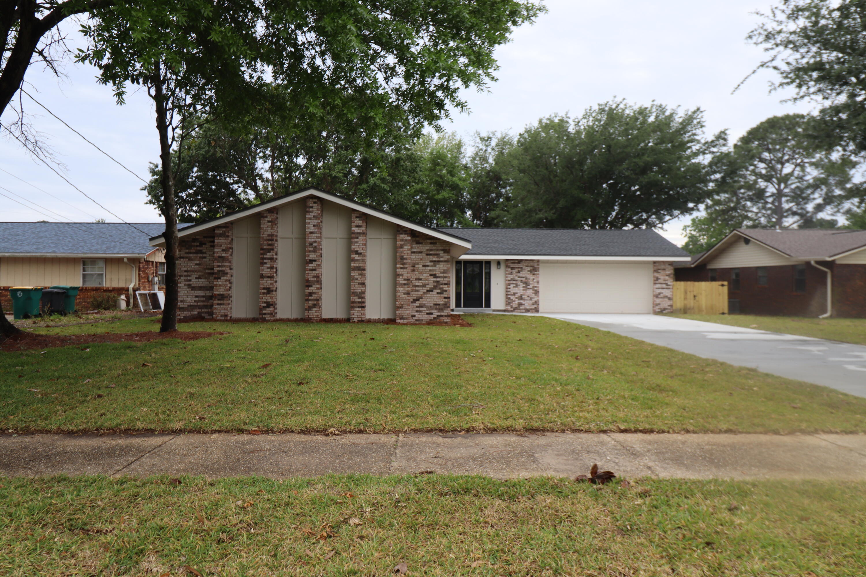 Completely remodeled lakefront home in Mary Esther, minutes away from Hurlburt and a short dive to beaches!! 3/2, 2CG, 1627 SF. New Roof, HVAC, insulation, drywall, doors, windows, cabinetry, light fixtures, updated electrical, plumbing, flooring, driveway, well and sprinkler system. Enjoy the low maintenance life. Kitchen boasts white cabinetry, granite countertops, breakfast bar, and Samsung stainless appliances. There are 2 spacious living areas, one with a bricked wood burning fireplace. Master bath has a huge tiled shower with glass enclosure. LVP flooring is installed in the main living areas, tile in the baths and carpeting in the bedrooms. Please call to schedule your showing today.