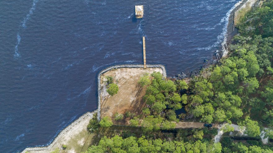 Stunning Bayfront lot measuring approximately 1/2 acre and 190' of water frontage, rip-rap is already in place to define the perfect site on which to orient your home.  A dock with a covered slip exists. Perfectly located only 10 minutes from the White Sands of the Emerald Coast and 30a and 15 minutes from Grand Boulevard. 

Survey available upon request; Time to build your dream Home!