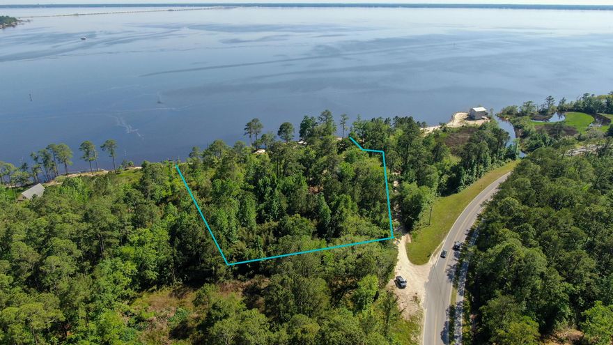 This large 2.65 acre waterfront property offers the perfect footprint for your customized dream home with 294 ft of unrestricted privacy for your own private oasis. Just a short boat ride across the bay and you can eat brunch or dinner at numerous waterfront restaurants. Enjoy paddle boarding, kayaking, and fishing off the banks or take a cruise on the bay in your boat. Currently this property offers 3 residential rental homes and they all have brand new roofs.  The waterfront cottage offers 1,554 sq ft with 2 bedrooms and 1 bath. The second home offers 1,643 sq ft with 3 bedrooms and 2 bath. The third home offers 1,200 sq ft with 3 bedrooms and 1.5 bath. Options are plentiful with this fabulous waterfront property. 