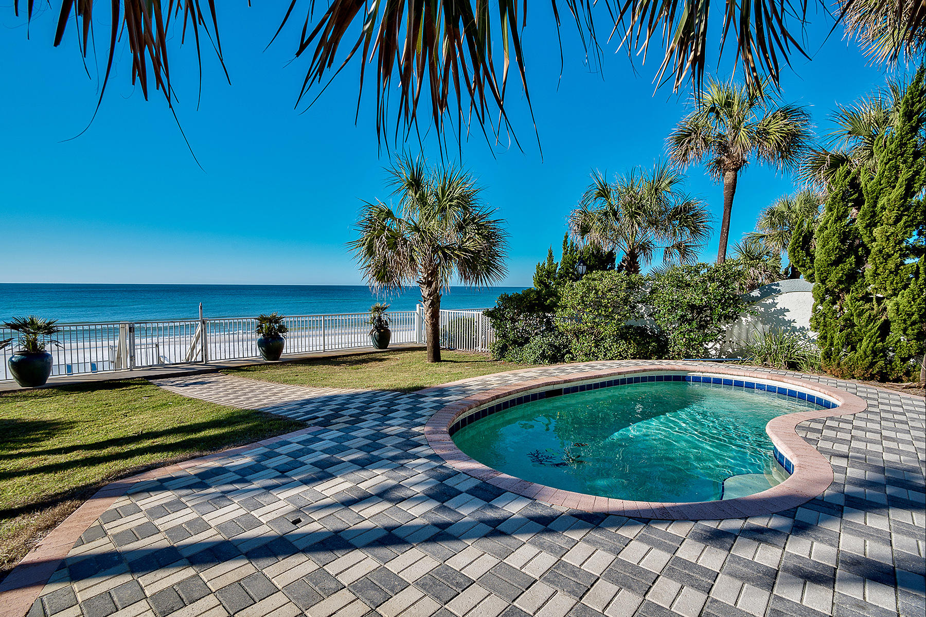 This idealistic beach front estate perfectly embodies old florida charm paired with captivating gulf views and strategically constructed well above sea level in Flood Zone X with concrete block siding providing longevity & peace of mind. This gorgeous property consists of .59 acres of land with 50' of private beach & ample room for parking; masterfully configured to maximize rental income (Owner will guarantee $220,000 in gross annual income for the 2016 rental season) with 6 bedrooms as well as a separate guest quarters providing optimal functionality. Notable features include a privately gated entrance, exceptional parking ability with room for 8 vehicles, private in-ground pool area presiding over an incredible gulf front vista & beautifully landscaped