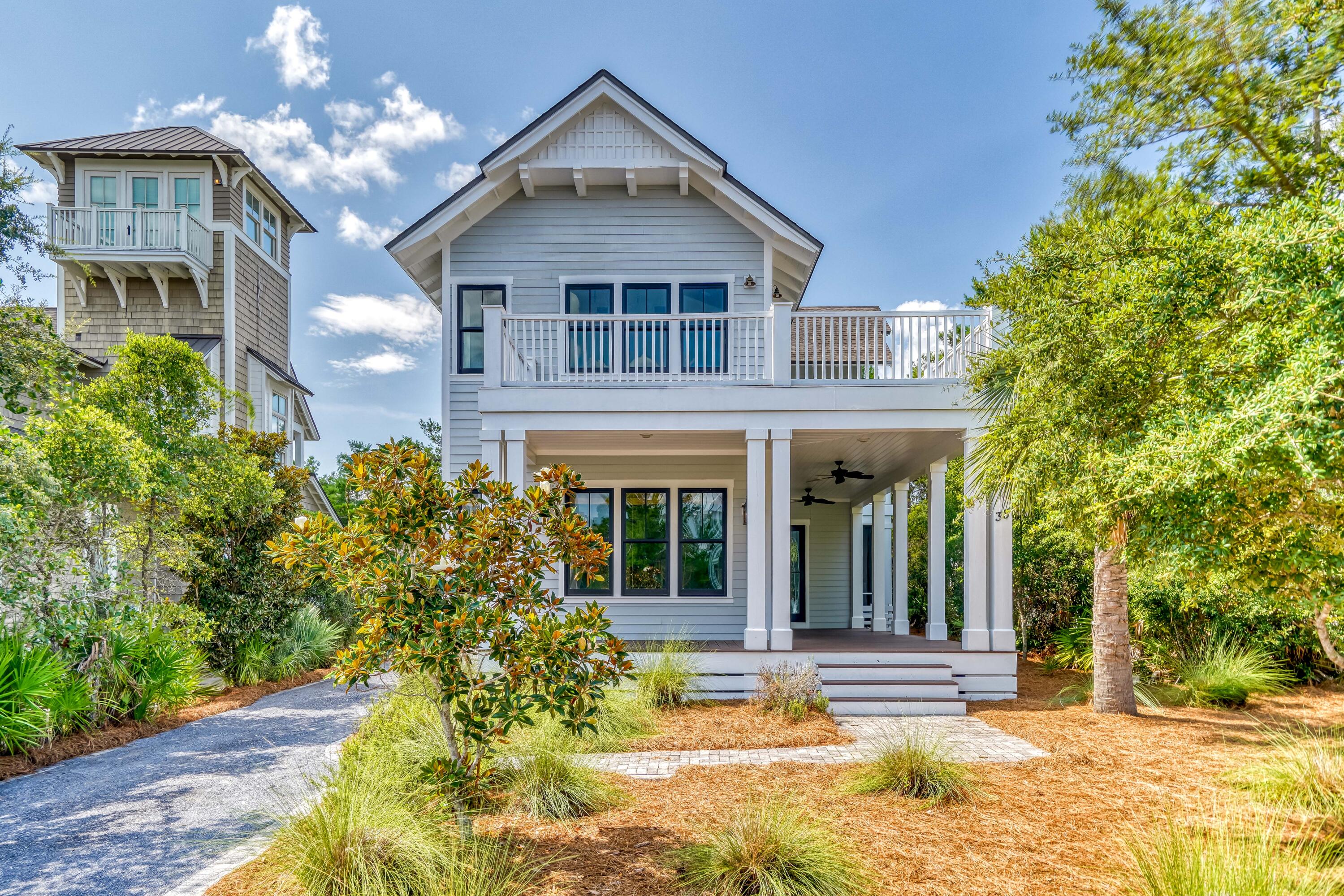 Nestled along a quiet street in the gated WaterSound Beach community, this property invites relaxation with 1,700 square feet of porches including a large screened porch with a 14' private spa. The sunlight-filled open concept living & dining area provides ample space for family gatherings with hardwood floors & board & batten wall detail.The kitchen features a large center island with marble countertops, custom white cabinetry, beautiful backsplash and commercial-grade stainless appliances including a wine refrigerator.A comfortable guest suite & powder bath are also located on the first level. Upstairs, find a spacious secondary living area complete with four built-in bunks. The serene master suite features a vaulted tongue & groove ceiling, a wraparound balcony & elegant ensuite bath.