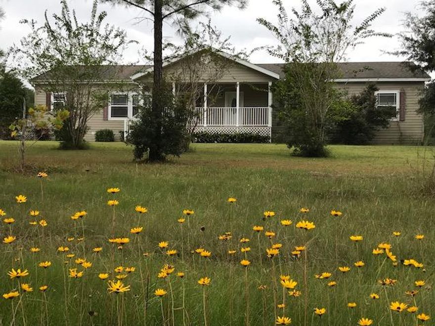 One of the nicest Manufactured Homes I have ever seen! Great floor plan, 9 ft, ceiling ht., spacious rooms, walk-in closets in Each Bedroom - ADDITIONAL ROOM THAT COULD BE A BEDROOM!!!! Spacious Front kitchen and Dining area, Ample, NICE cabinets plus pantry - Range 4 Yrs. old. ref., 9 yrs old. Fireplace is wood burning, but has a gas line so gas logs can be added. Nice large Covered Front Porch and large covered DECK that is the same level as the Above Ground Pool - great place to relax and enjoy! The exterior walls are 2 X 6, and the siding is Hardy Board, Shingles Dimensional. The way the property is situated, no one can built near to the Right. Full Acre! CL Fenced back yard for children or pets! NOTE: SELLER IS GIVING $4,000 FLOORING ALLOWANCE. Great price for this amount of SF
