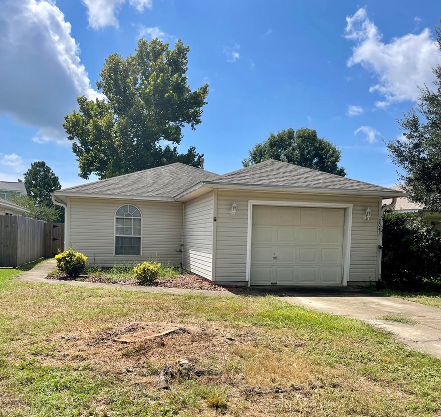 Resting in the quaint community of Coral Village amidst manicured grounds and mature trees this darling cottage provides for a carefree lifestyle and minimalistic approach. With its relaxed and undemanding character, this home would be the perfect opportunity for a first-time home buyer or investor. From the moment of arrival, you'll notice the convenient one car attached garage, easy vinyl siding, and fully fenced yard. You are led to the side entrance of the home by the sidewalk that is bordered by developed shrubberies. As you enter through the glass paneled door, you'll notice the bright and airy space that introduces an open concept floorplan flanked with a ceiling fan, adjoining dining area, and open kitchen. The home comprises wall to wall carpet that allows the floorplan to flow