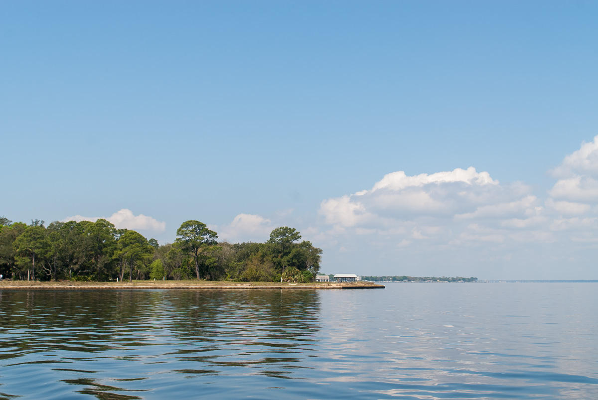 The Estates at Indian Pointe is a gated enclave of Bay and Bayou front home sites in Destin, Florida. This .62 acre Bayfront lot gives the avid boater direct access to the water. Tucked away at the very east end of Indian Trail, occupying what is perhaps the most remote waterfront location in Destin, this especially private piece of property is only an 11 minute drive from beach access with parking, as well as shopping, dining, seasonal entertainment, and chartered fishing excursions at Harborwalk Village on the Destin Harbor. The Estates at Indian Pointe is the pinnacle of luxury waterfront living for those who refuse to compromise the beach lifestyle in order to pursue their passion for boating.
