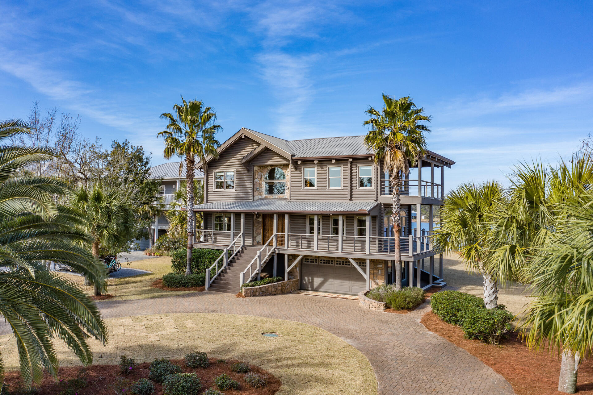Incredible 3 story, 5000 sq ft bay front log home with spectacular views from nearly every room. The home sits on 5 acres and is surrounded by water on 3 sides. Includes 5 docks and one 23k lb boat lift. From the tongue and groove walls to the river recovered heart of pine floors this home is 5 star. The house has a Guardian Air Purification System. The 1000 sq ft master suite has a huge walk in closet, 400 sqft balcony, fireplace, onyx counter tops, brass tub and double rainfall shower. The kitchen has a Sub Zero fridge, Wolf steamer, Meile coffee system, gas stove, double oven, a walk in pantry, and lots of cabinets. This property has over a 1000 feet of water frontage. There are no better views anywhere! See More for list of updates!