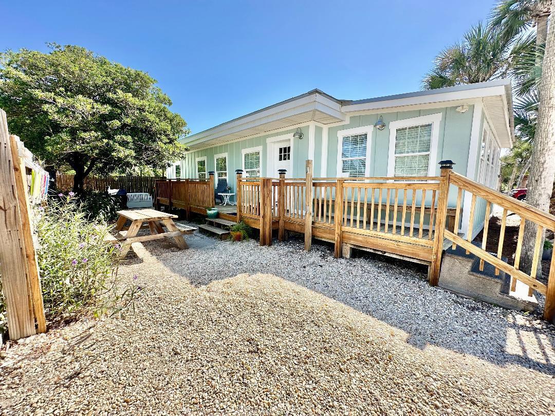 Adorable Cottage Directly on Front Beach Rd-across the street from the beach at Beach Access # 83. No HOA! 3 bedrooms with a bonus room & 2 full baths. Excellent rental with a deep lot, room for expansion, pool or carriage house. The cheerful coastal decor compliments the vintage touches throughout. Updates have been styled to preserve the original character of the Florida Beach Cottage. Endless hot water; Exposed Beams; Updated Flooring, Cabinetry; Granite Countertops; and GE Vintage Replica Appliances are a few of the added features. Future rentals available to the buyer.