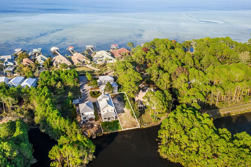 Build your dream home in Miramar Beach!. This gorgeous lake front lot is located in the heart of Miramar Beach across from the Bay and just 1.5 miles from the beautiful beaches of the Gulf of Mexico. The lake flows to the Choctawhatchee Bay via Creek, making it perfect for outdoor activities like paddle boarding and kayaking. This rare vacant lot is ready for construction as tap fees have been paid, the lot has been cleared and a seawall is in place. There is no build out time and the homeowners association is inactive and does not collect dues. County approved house plans and survey are available upon request and will convey with the sale of the property.