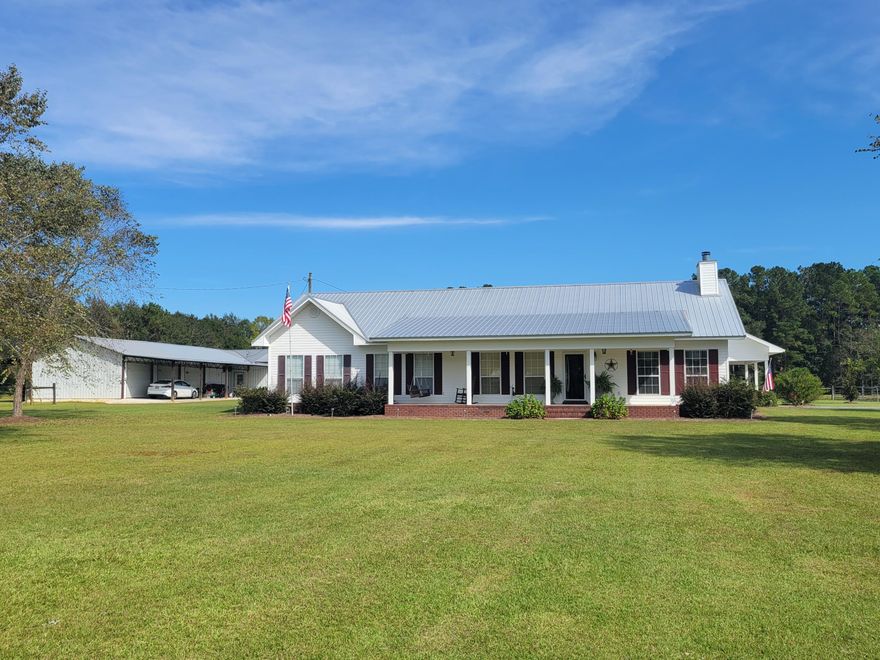 14 acres with a beautiful vinyl sided  country home with brick trim and metal roof.  Home has  4 bedroom and 2 baths.  Other amenities include metal workshop building with four bay garage doors and includes water and power and an office with 1/2 bath, pole barn, and small pond. Back yard includes a fenced In-ground pool next to the two car carport that has additional attic storage. Interior of home has fireplace, spacious room sizes; kitchen has breakfast bar and lots of oak cabinets, all appliances included.   Seller to give a credit towards a new HVAC system.  The house is working well;  Buyer can have installed after closing. Keep reading==Click on 'MORE' The one that in Custom built in 2001 with extra energy features such as every third stud in the walls is doubled, double  attic insulation, double hurricane clips and double pane windows.   There is a walk way down the center of the attic.