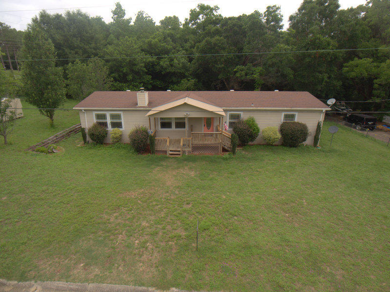 This four bedroom/ 3 bath home has brand new carpet in all 4 bedrooms as well as newer vinyl flooring in great room. There is a wood burning, corner fireplace, large open kitchen with a center island, newer microwave, gas cook range, 2 water heaters and a newer air condition system installed. Outside, you will find a large lot with room to run, store additional RV, Boat etc. or build a work shop. There is no Homeowner's association attached to this property. Centrally located in the center of town for convenience, yet located on a quiet dead end street with very little traffic and much privacy, you will really enjoy the large lot and the large home for a small price! This home comes with a one year home warranty provided by the seller.