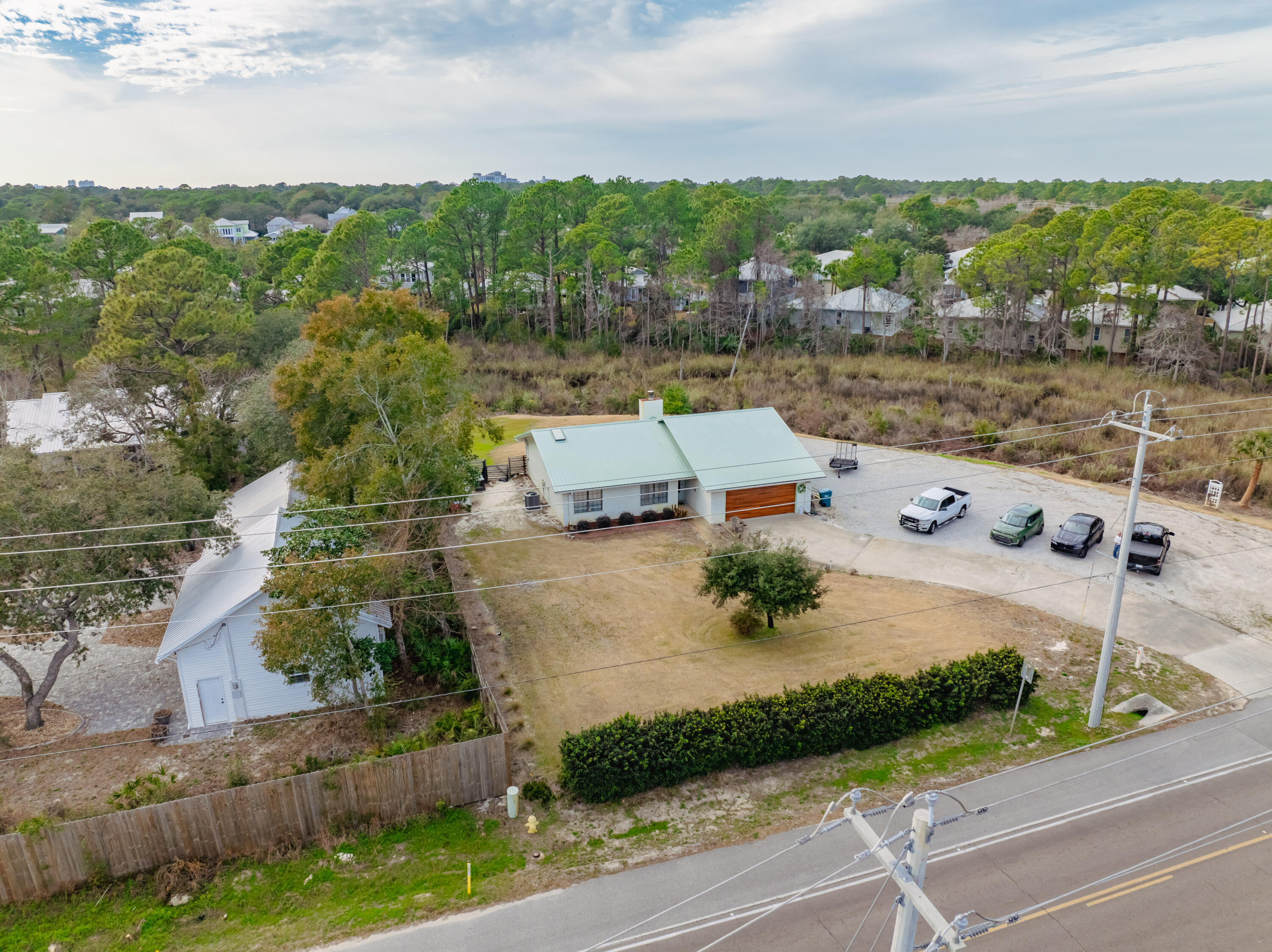 Welcome to this incredible opportunity to own over an acre of land on Mack Bayou Road, offering the perfect blend of privacy and seclusion, yet still close to all the amenities you need. This charming three-bedroom, two-bathroom home boasts a modernized kitchen with updated counters, cabinets, and a farmhouse sink. Both bathrooms have been refreshed with new counters, and throughout the home, you'll find LVP wood-like flooring that adds a stylish touch. The open layout features raised ceilings, allowing for plenty of natural light to fill the space, creating a bright and airy atmosphere. Outside, enjoy a serene outdoor patio that overlooks the peaceful creek running along the property, perfect for relaxing or entertaining guests. With ample parking space and a two-car garage, this home is ready to host family and friends. Additionally, the property is zoned as Coastal Center, meaning it's not just a residential gem but also listed as a commercial property - offering even more potential. Don't miss out on this unique opportunity!