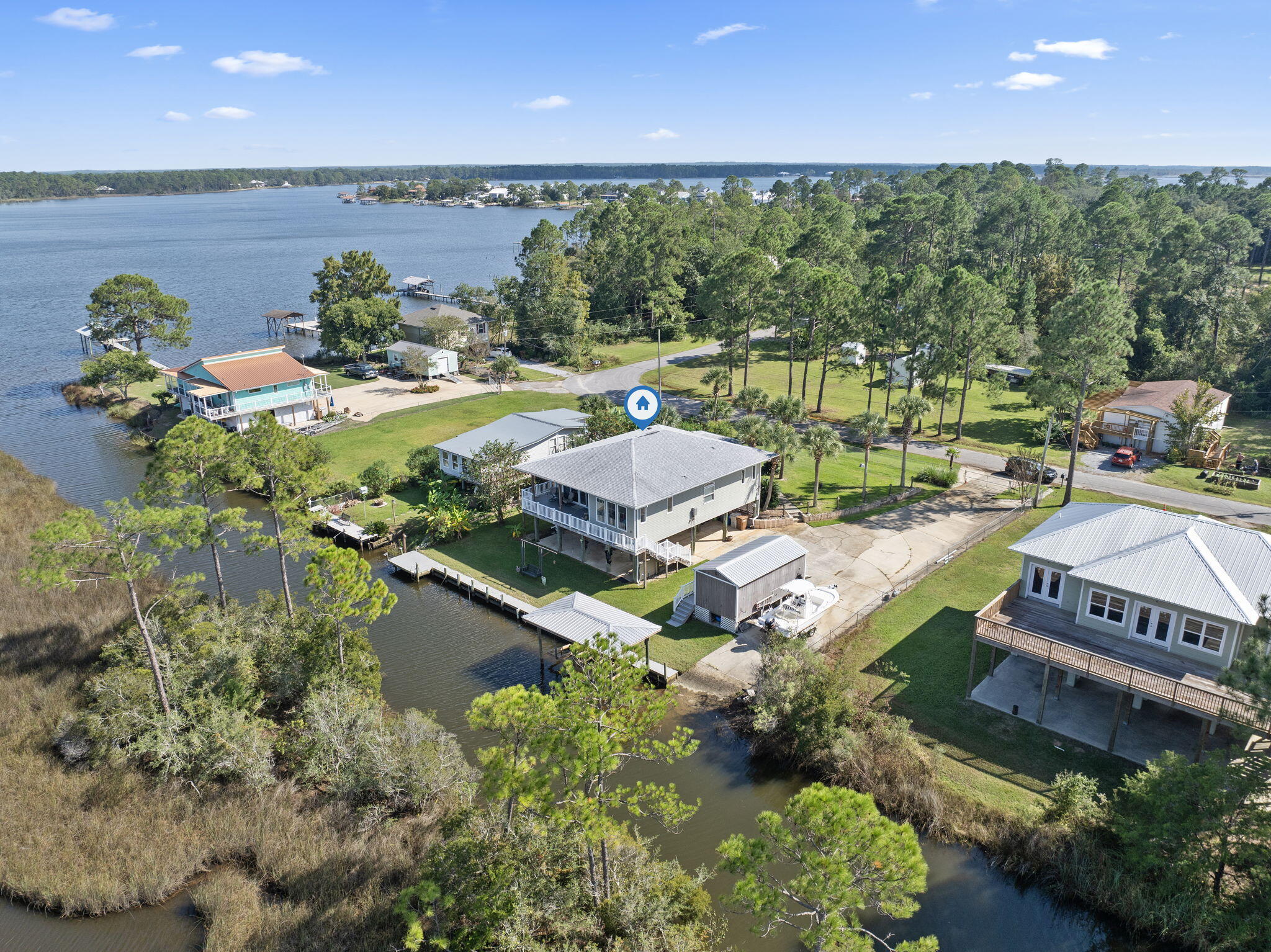 Welcome to your very own waterfront paradise! This stunning 3-bedroom, 2-bath home, partially furnished and meticulously rebuilt in 2018, offers over 100 feet of pristine water frontage. Imagine waking up to breathtaking sunrises and unwinding with sunsets from the comfort of your backyard waterfront swing. The property is perfectly situated on a canal in Ward Basin, leading into the serene Blackwater Bay, and your private boat ramp provides easy access to long days spent on the Bay. The lot is beautifully lit and equipped with a seawall, private boat ramp, covered boat lift, and ample space for outdoor seating and entertaining. You'll also find a separate storage workshop with electricity, ideal for all your hobbies and storage needs. Step onto the covered porch, where two ceiling fans p rovide a gentle breeze, or retreat indoors to your dream home. Experience your unparalleled waterfront views from the elevated design of this stunning home, complemented by the added convenience of an exterior elevator. This thoughtful feature ensures effortless access to the main level, enhancing your comfort and enjoyment. The interior boasts shiplap ceilings and custom hand-scraped doors, showcasing exquisite attention to detail. The kitchen is a chef's delight, featuring beautiful cabinets, a stylish backsplash, leathered marble countertops, and a spacious island for additional workspace and seating. The primary bedroom overlooks the water, and the primary bathroom is a sanctuary of luxury, complete with a picturesque soaker tub, a beautifully tiled walk-in shower, and a double vanity. Whether you're looking for a perfect part-time getaway or a full-time residence, this home offers an unparalleled escape. Experience the tranquility and charm of waterfront living on Sunfish Ln. and make this one-of-a-kind property your own!