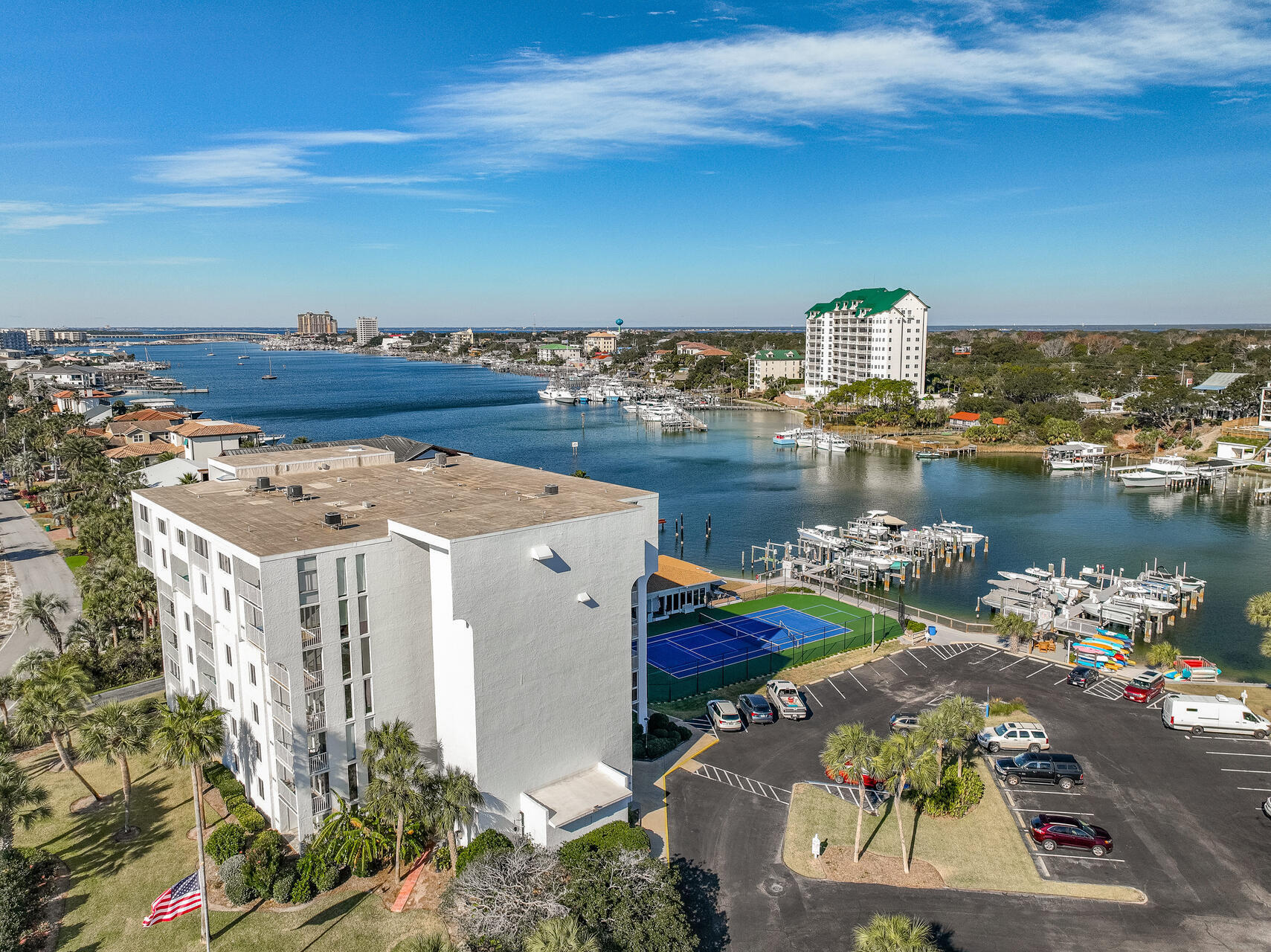 Fantastic 4th floor waterfront condo located on Holiday Isle. Turn-Key vacation rental (sold completely furnished including bicycles and kayak), vacation home or permanent residence. Completely refreshed with unobstructed view of Destin Harbor. Watch the dolphins swim by from your waterfront balcony. This unit is gorgeous, with quality, tasteful furnishings throughout.Ceilings are white shiplap, fresh neutral paint throughout. Premium luxury vinyl flooring throughout - no carpeting! All new Impact Windows and Sliding Doors, HVAC, water heater and garbage disposal. Kitchen has granite countertops, stainless steel appliances, fresh white cabinets and food pantry. Master bedroom with en-suite bath and generous closet. Bathrooms upgraded - tile, showers, vanities. Washer/dryer hook-up. Included is a 15' x 5' storage unit located on the same floor that can be used as owner storage or vacation rental storage. The Dolphin Point community has excellent onsite property management. Amenities include tennis and pickle ball courts (newly updated), pool, club house and marina. Access to the beautiful Gulf of Mexico and private Holiday Isle white sand beaches are at the end of the street. Your condo dues include water, internet and basic cable.
