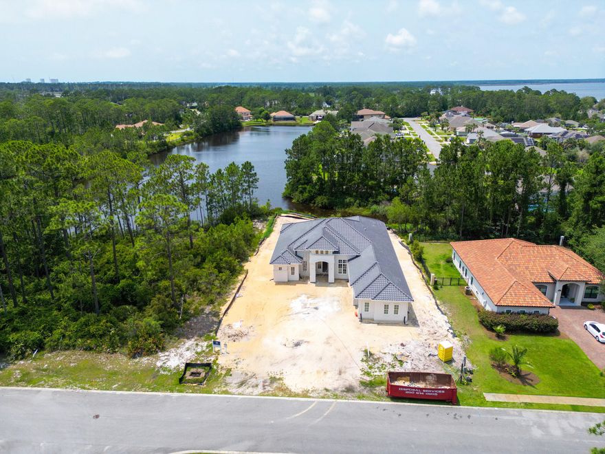 This STUNNING NEW CONSTRUCTION home is currently being built in the much sought after GATED community of Trieste.  This home is perfectly designed for entertaining with the spacious open kitchen and living areas and backs up to the lake.  The home is adorned with 10-to-12-foot ceilings, a large lanai off the master and living area,  a spacious garage, a 4th bedroom that could be used as an office and a separate den for additional living space.  This upscale neighborhood is known for its Mediterranean styled homes and is just minutes to all the dining, shopping, entertainment and of course the beaches that Panama City Beach is known for.