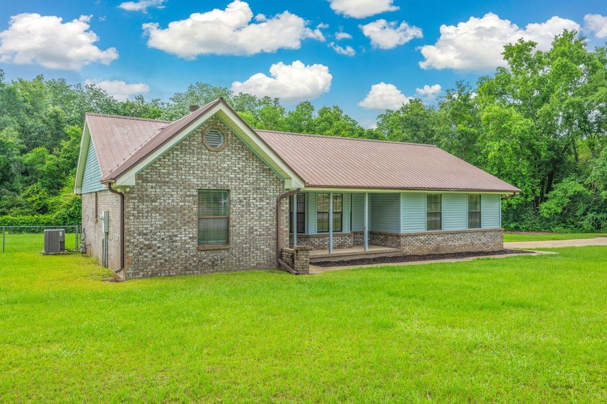Tucked away on nearly 2 acres of serene land, this charming single-family home offers the perfect blend of rustic warmth and updated convenience. Step inside to a cozy living room featuring a stunning stone fireplace that burns both wood and gas--ideal for creating the perfect ambiance year-round.The thoughtfully designed split floor plan ensures privacy and functionality, while the kitchen is a cook's dream with a gas stove, updated stainless steel appliances, and plenty of space for gatherings.Enjoy the freedom of wide open spaces with a large deck perfect for entertaining or quiet mornings overlooking the partially fenced backyard.