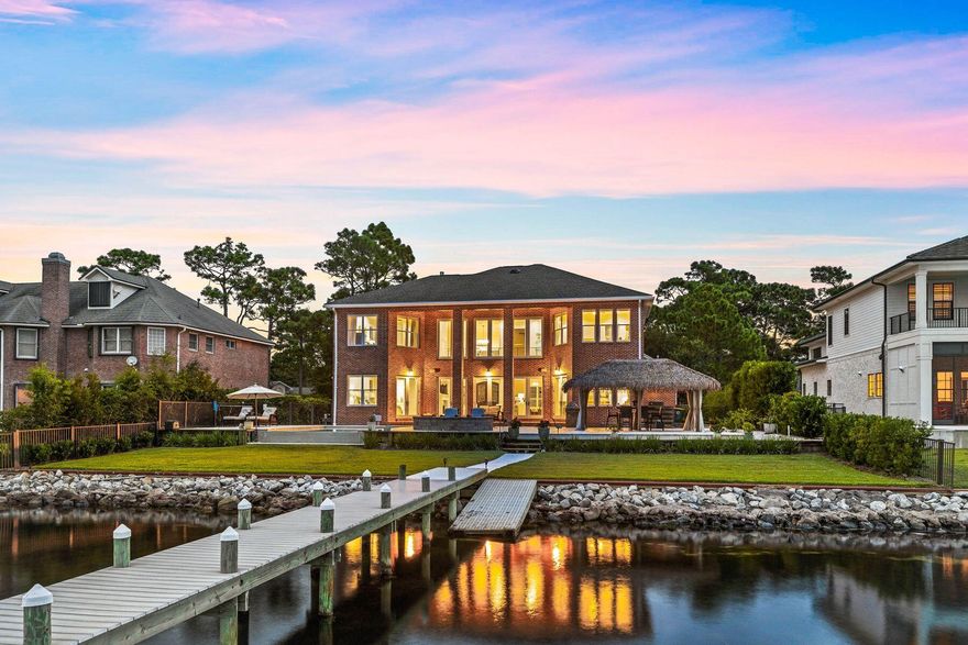Experience unparalleled luxury and breathtaking waterfront views at 205 Baywind Drive, located in the prestigious, gated community of Southwind within Bluewater Bay. This meticulously updated 2007 residence is a testament to elegance and resilience, built with Insulated Concrete Forms (ICF) and boasting over 12-inch-thick exterior walls, a durable brick exterior, a hip roof, back and side impact windows.As you step into the grand two-story foyer, you're immediately captivated by the mesmerizing blue waters of the bay, visible through the expansive wall of windows in the two-story living area. This space flows seamlessly into the open-concept kitchen, spacious breakfast nook, cocktail area, and dining room, creating the perfect setting for both entertaining and everyday living.