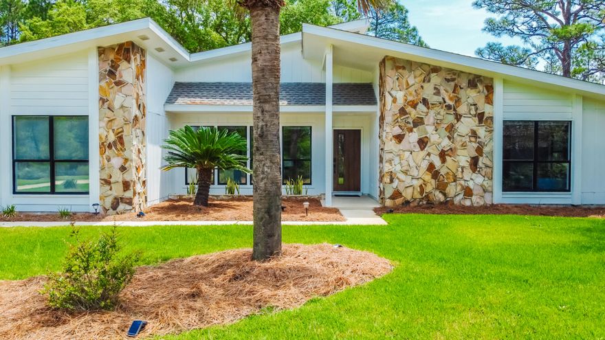 Beautiful home with a large outdoor area in Holley By The Sea! Located within 5 miles of Navarre Beach, the property showcases many updates including a newer roof, new exterior doors & updated bathrooms. The peaceful back yard space includes an open courtyard surrounded by native plant life & woods, covered outdoor grill area & new landscaping throughout. The bright interior features a spacious living area, vaulted ceilings, new light fixtures & flooring, along with new cabinets, quartz countertops, stainless steel appliances, & range hood in the kitchen. Updates also include insulated garage door & electric opener, SunTek's Ultravision ULVDS-40 window film on all windows, & tankless natural gas hot water heater. Enjoy access to the Holley By The Sea recreational facility across Hwy 98.