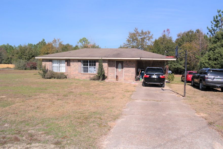 Great potential on this affordable brick home on 1 ac within 20 minutes to Defuniak Springs or Crestview. 10 minutest to I-10 in Mossy Head for a quick, low traffic commute to Niceville, Eglin AFB, FWB. Nice open floor plan makes this smaller home feel much more roomy. Other features include a generous laundry room and attached 1-car carport. Schedule your showing today!