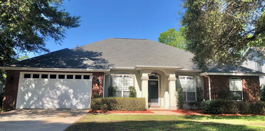 Come see this luxury Bluewater Bay home overlooking a lake in an amazing location conveniently located to the Mid Bay bridge, shopping and ''A'' rated schools. Enjoy the breeze and water views from the large 316  sq ft screened Florida room. Interior boasts hardwood and 18'' tile flooring with carpeted bedrooms and hallway. The  front door has a keypad/touch entry and the entrance hall opens to spacious family room with gas fireplace, vaulted-tray ceilings, crown molding and recessed lighting. The open plan great room borders an eat in kitchen with a breakfast bar and the large master bedroom features a walk-in closet and an adjoining master bathroom with double sink vanity, separate shower and whirlpool tub. Schedule your appointment to see this beautiful home today!