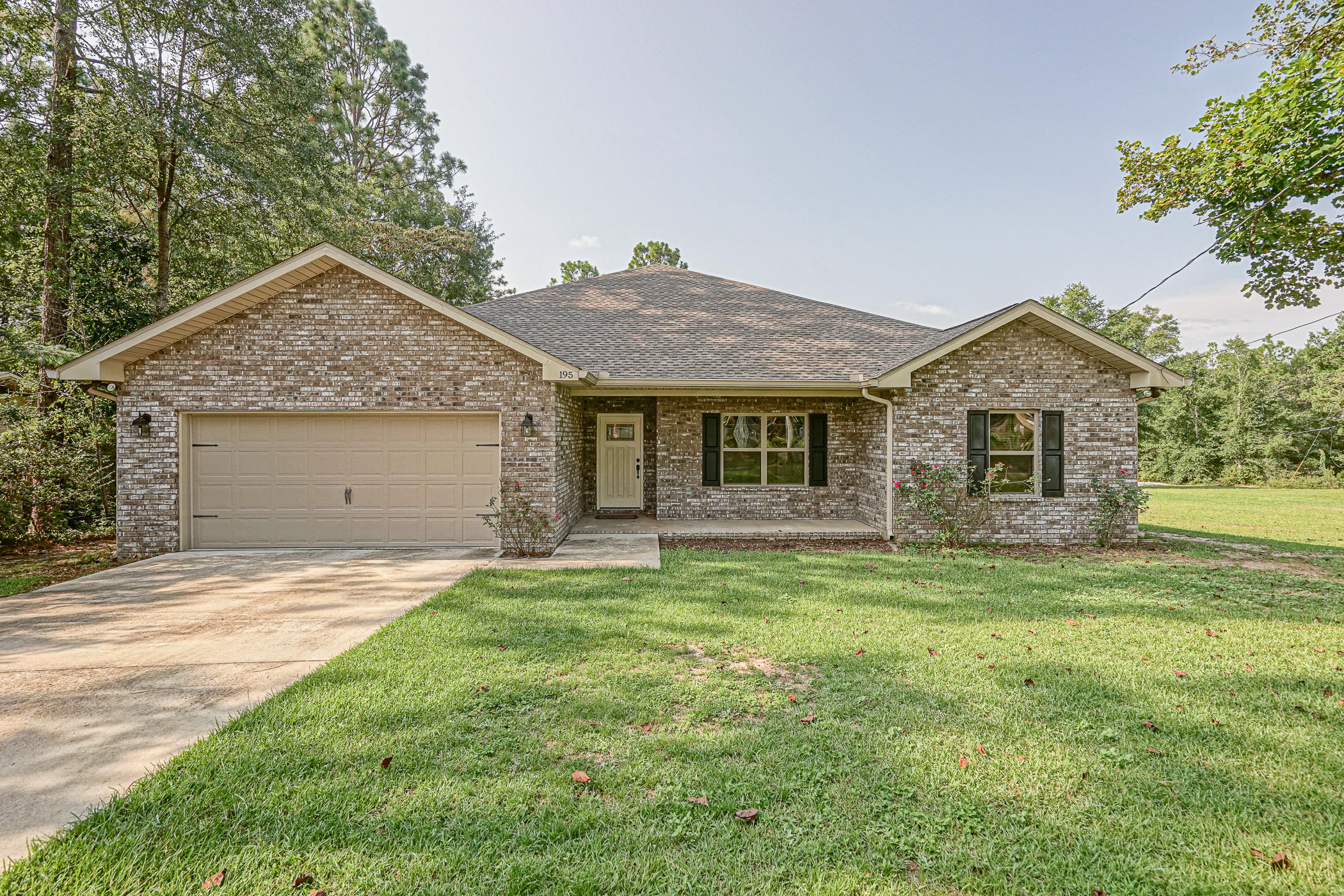 Welcome home to 195 Ridge Drive! This like-new home was built just 3 years ago and features wood look tile floors throughout the home. Wall to wall carpeted bedrooms for comfort. Trey ceilings in Master bedroom and Living room give you a spacious area to lounge in. Breakfast bar/kitchen island is adjacent to the Living Room in this wide open floor plan making it easy to entertain audiences. Kitchen has granite counter tops, stainless appliances, and gorgeous cabinetry. Large closets throughout home for extra storage space. Bathrooms, kitchen, living room all feature recessed lighting! Call to schedule your showing today! This sale also contains the lot for 193 Ridge as well.