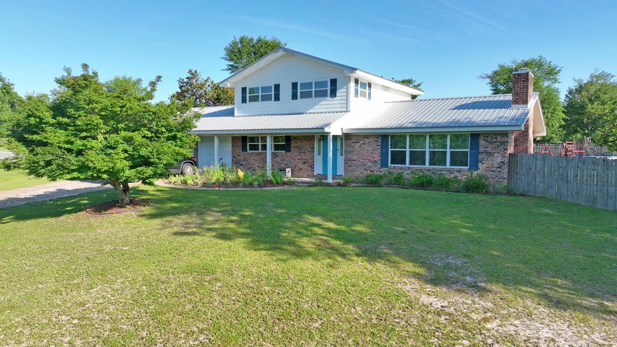 Welcome to 11152 N Bear Creek -- your peaceful retreat with space, style, and charm. Located in a gorgeous, quiet area just minutes from Deer Point Lake, this updated 5-bedroom, 3.5-bath home sits on 1.75 high and dry acres with no HOA and a pool! Enjoy the perfect blend of rural privacy and convenience -- you're less than 20 minutes to Lynn Haven, shopping and dining on Highway 77, and highly rated schools like Mosley High School and North Bay Haven Charter Academy. Quick access to boat ramps, parks, and only about 30 minutes to Panama City Beach. This nearly 2,400 square foot home has been thoughtfully updated throughout, including new windows, doors, flooring, kitchen, and water heater. The open-concept layout allows the family room, dining area, and kitchen to flow together for easy  living and entertaining. A cozy wood-burning fireplace adds warmth and charm, while two spacious master suites provide flexibility for multi-generational living or guest space. A large additional flex room is ideal for a home office, home-school setup, craft room, or playroom. Outside, the fenced backyard offers room for it all  RV, boat, pole barn and space to throw a football or relax with a peaceful sunset after a cookout. The landscaped yard includes fruit trees and curb appeal, while the metal roof and two-car garage add long-term value and function. If you're looking for space, charm, and peaceful living close to town, this one checks every box. Come tour 11152 N Bear Creek today  your forever home might be waiting here.