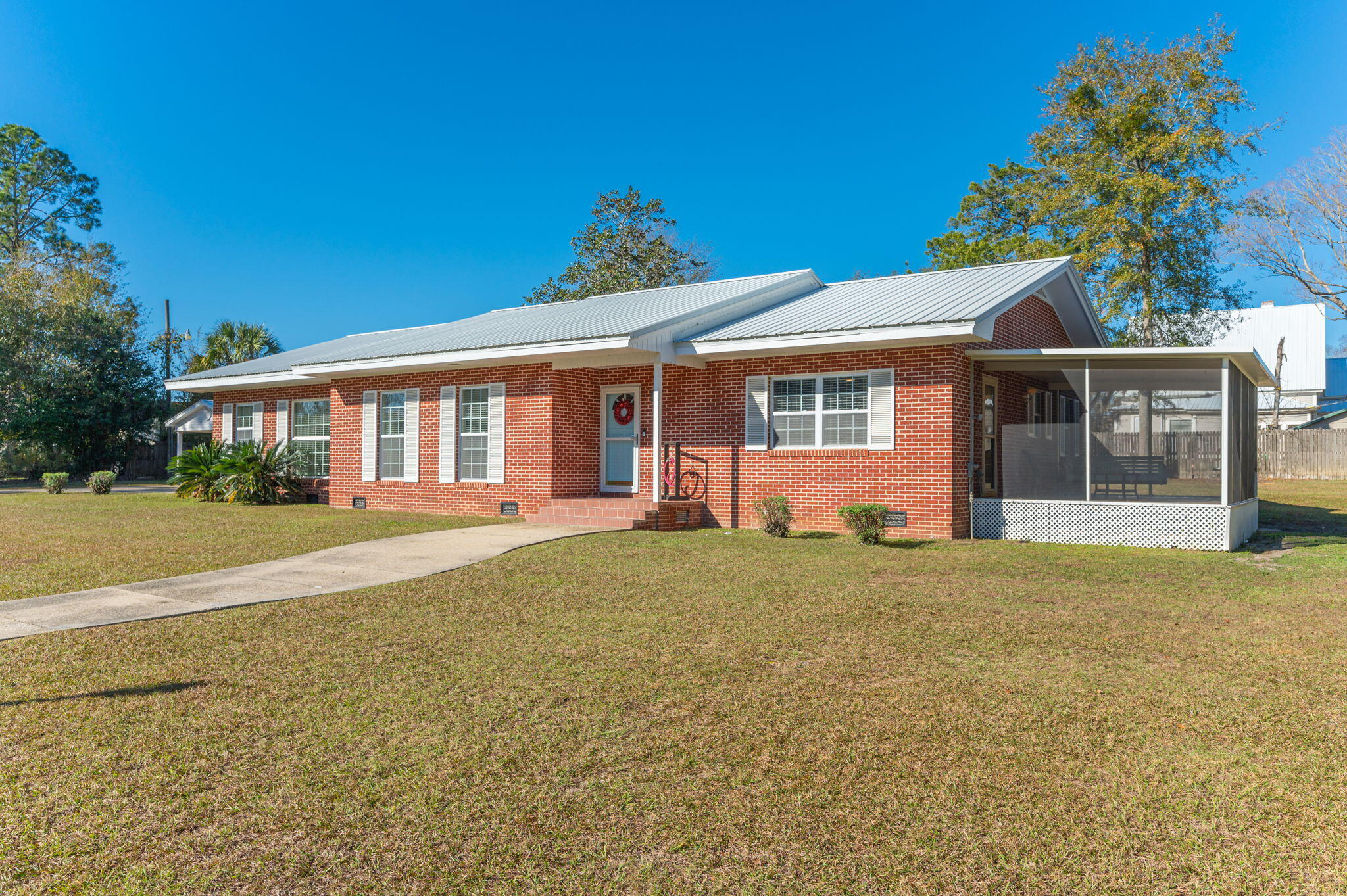 Just one block off Lake Jackson this 3/2 brick home has everything you are looking for! Offering a large, remodeled kitchen with double ovens, tons of cabinets and counter space, and an eat in area. Living room is a welcoming area to the front of home with formal dining and the rear of the home offers a great family room with built ins and gives you access to large covered back patio and backyard. Home master suite offers original tile bath, walk in closet and is just the perfect size. The 2 additional bedrooms are great size and has a full bath for guest and bedrooms. Home has a screened in porch off one bedroom for perfect relaxing and is great as a mother-in-law suite or older child's room. Property is 0.70 of acre, paved drive, 2 car detached carport, great workshop in back yard